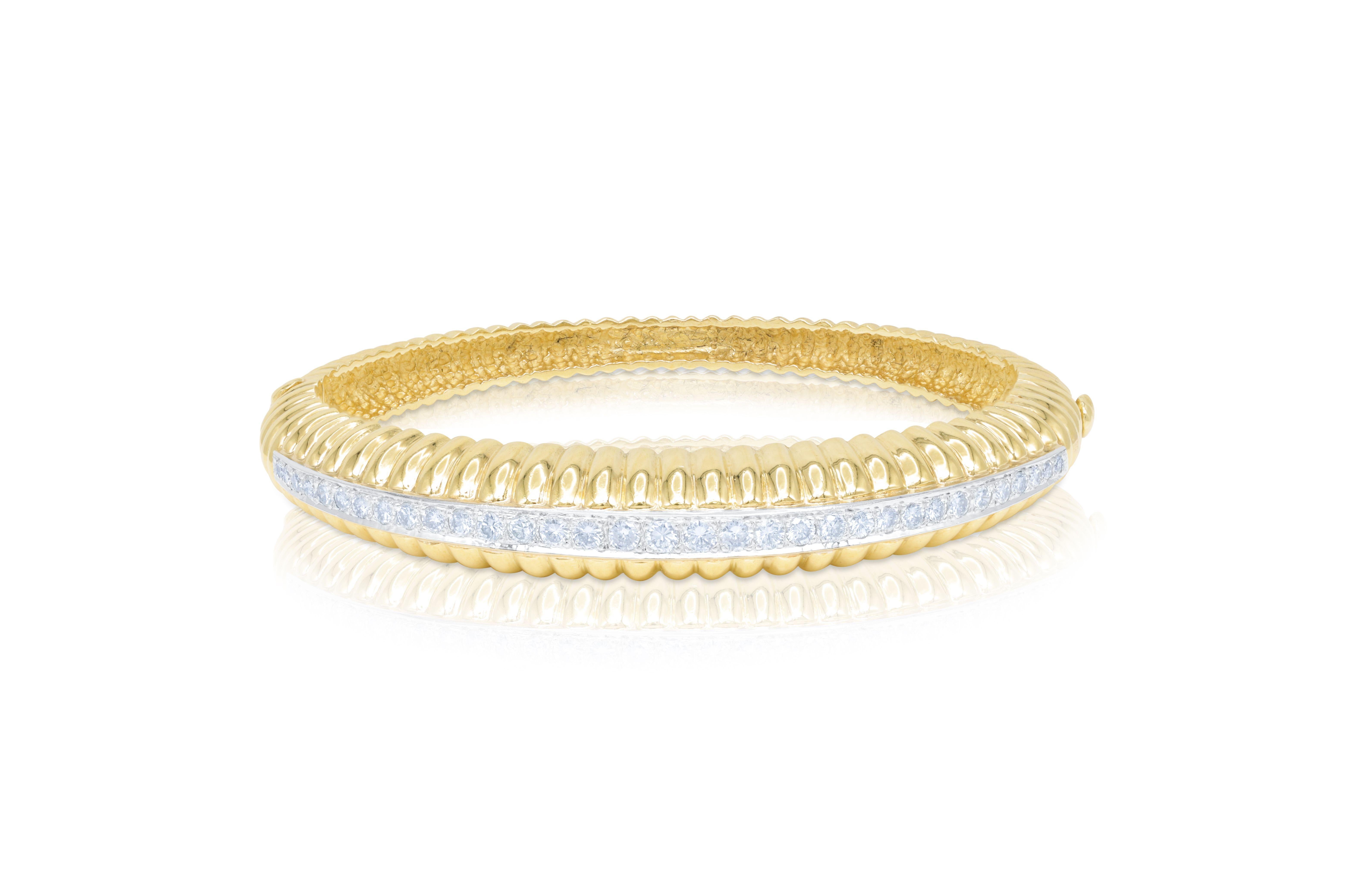 18 kt yellow gold bangle bracelet adorned with a center strip of 18 kt white gold adorned with 1.60 cts tw of diamonds