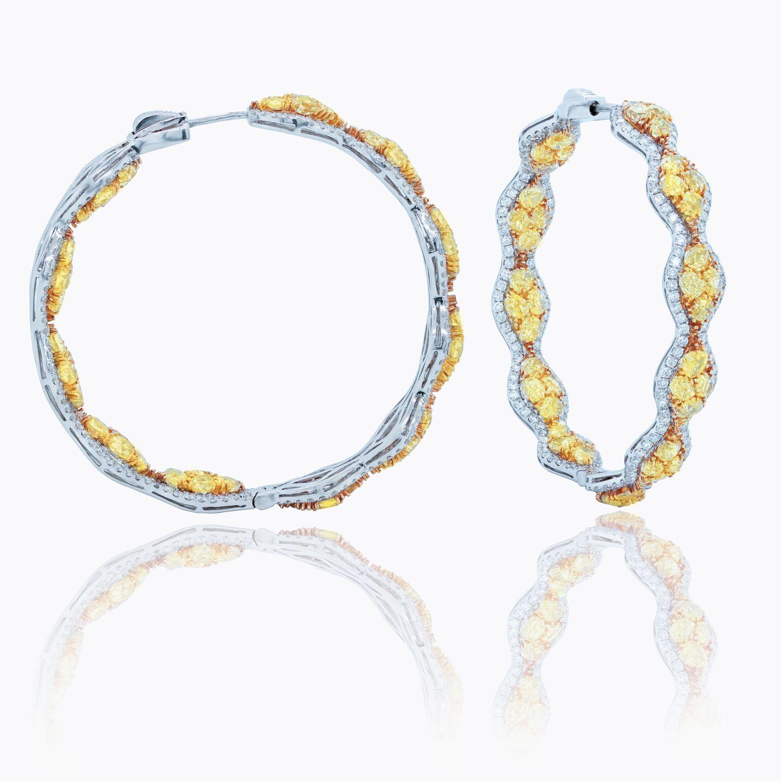 18 kt white and yellow gold inside-out hoop earrings with a double wavy design lined with white diamonds and adorned with yellow diamonds totaling 13.00 cts tw.
Diana M. is a leading supplier of top-quality fine jewelry for over 35 years.
Diana M is