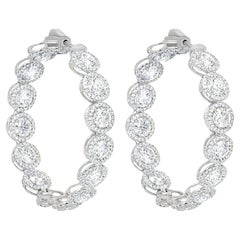 Diana M. 18 kt white gold, 1.50" inside-out hoop earrings with 12.20cts halo 