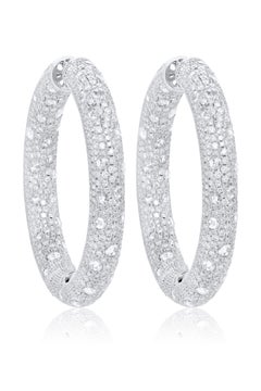 Diana M. 18 kt white gold, 2.25" inside-out hoop earrings adorned with 27.52cts