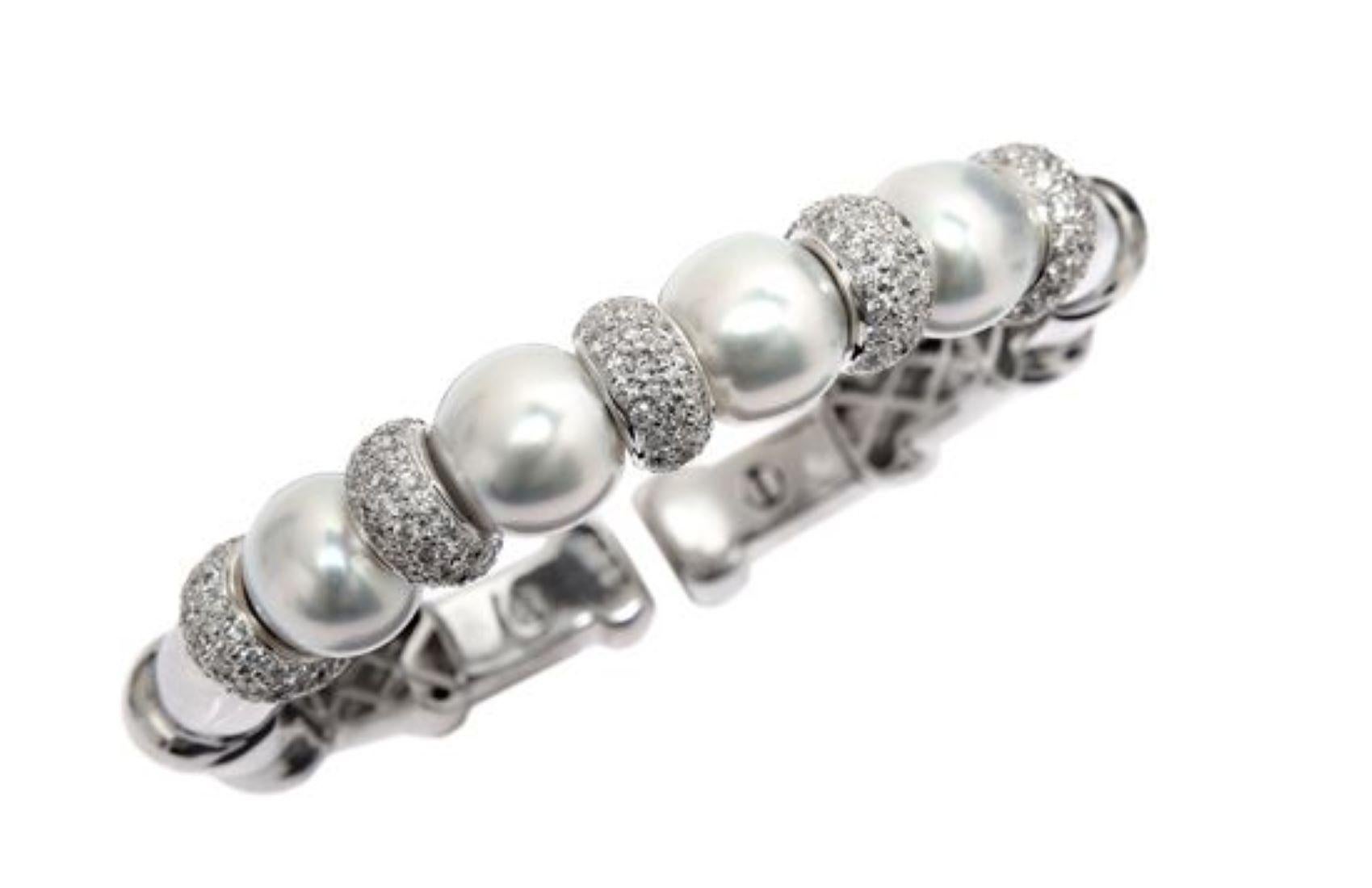 18 kt white gold diamond and pearl bangle cuff featuring four 11.8 mm south sea white pearls separated by rondels adorned with 3.17 cts tw of white diamonds