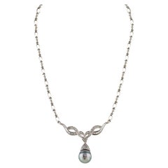 Diana M. 18 kt white gold diamond and pearl necklace featuring a center 14.00mm