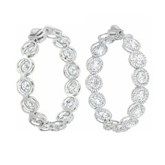 Diana M. 18 kt white gold inside-out hoop earrings with a halo design
