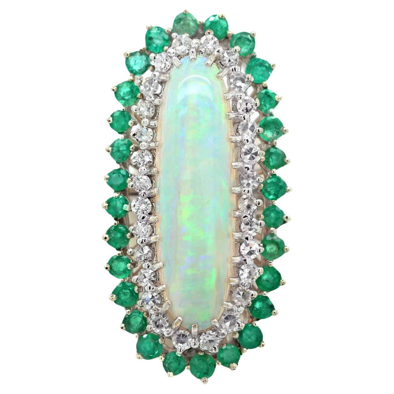 Diana M. 18 kt white gold opal, emerald, and diamond ring featuring a 7.00 ct  For Sale