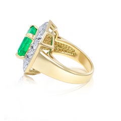 Diana M. 18 kt yellow gold emerald and diamond ring featuring a center 3.70 ct