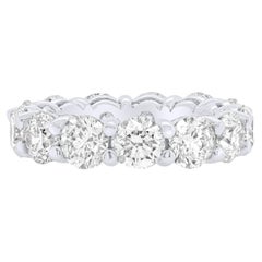 Diana M. 18kt white gold all the way around diamond weddings band feature 6.60ct