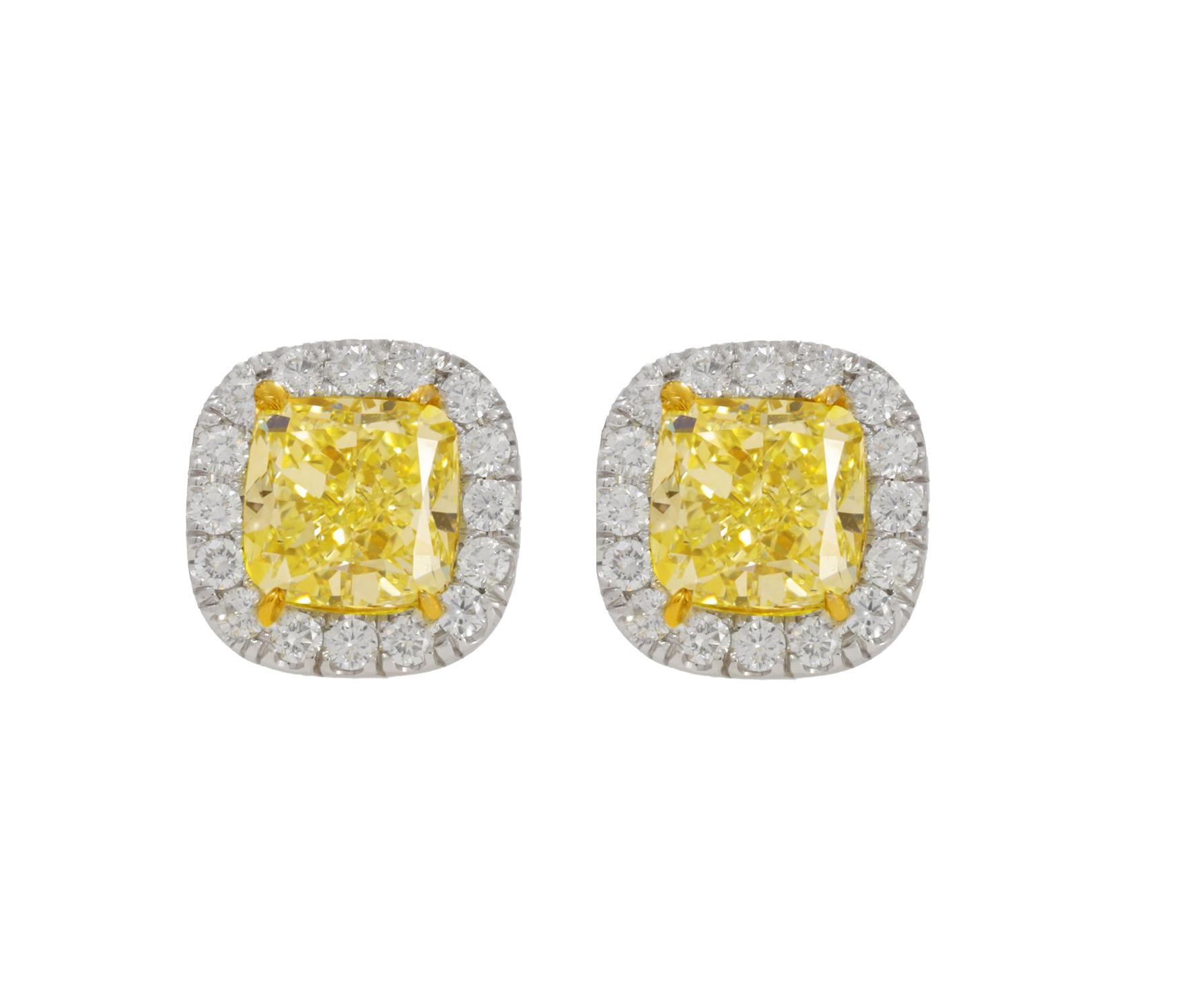 18KT WHITE GOLD DIAMOND STUDS, FEATURES 1.50CT + 1.51CT  OF TWO GIA CERTIFIED CUSHION CUT DIAMONDS FANCY YELLOW VS2-IN A DIAMOND HALO .40CTS OF DIAMONDS ON SIDES.
Diana M. is a leading supplier of top-quality fine jewelry for over 35 years.
Diana M
