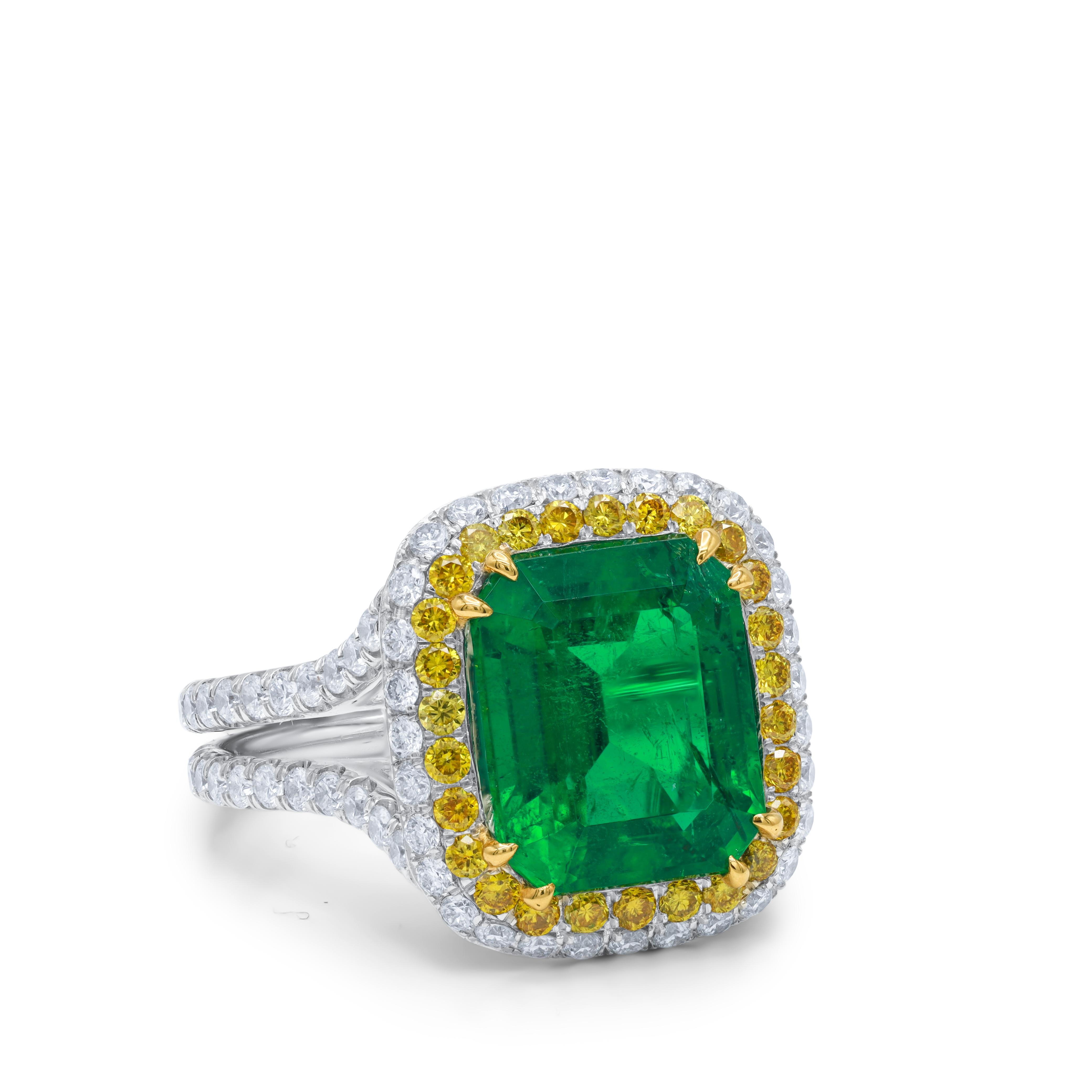 18kt white gold emerald diamond ring.  Featuring a 3.97 ct green emerald with 2.80 cts tw of yellow and white diamonds set in a split shank halo setting 
