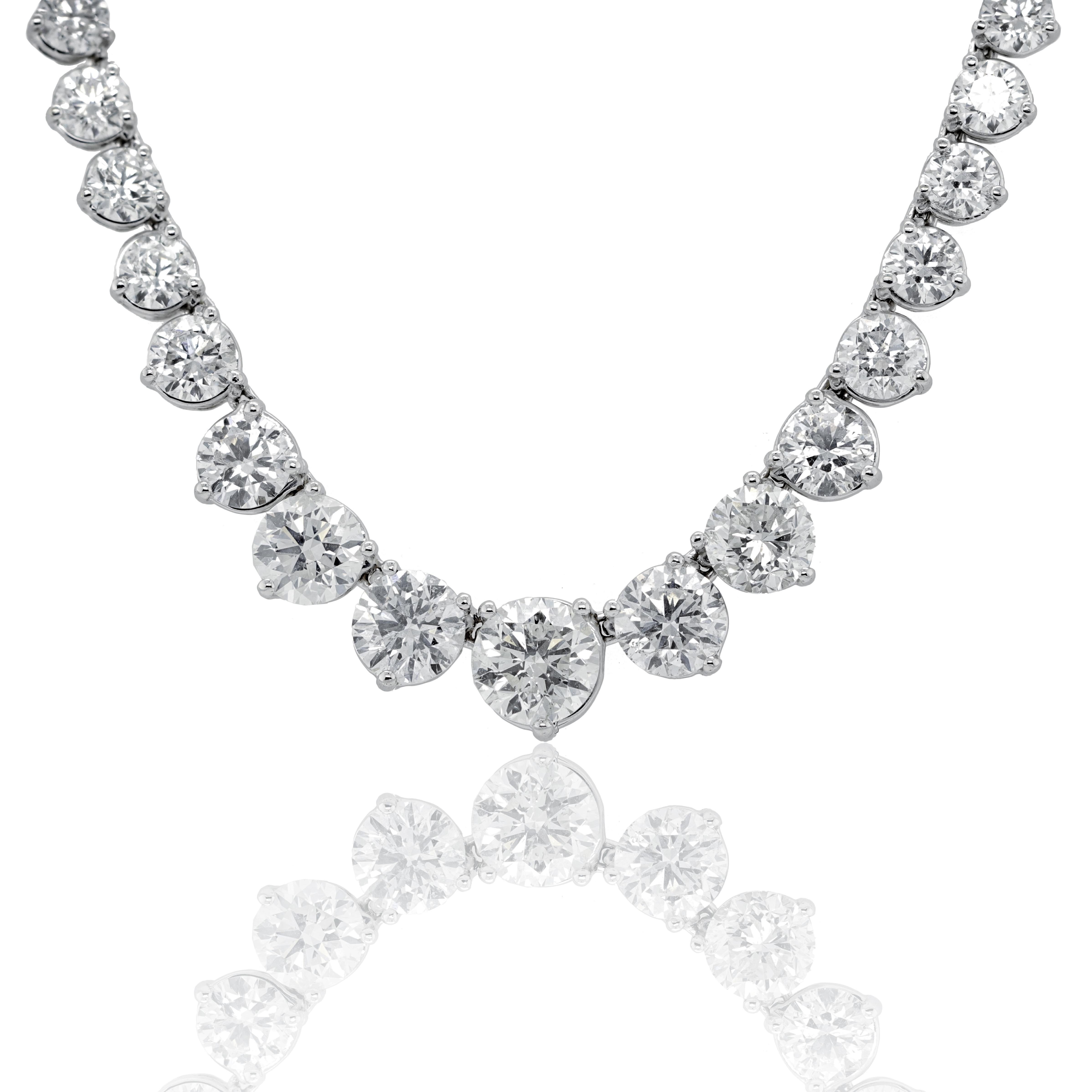  Custom 18k white gold graduated tennis necklace featuring 23.60 cts of round brilliant diamonds  89 stones 0.27 each  set in a 3 prong setting FG color SI clarity. Excellent  cut. 
