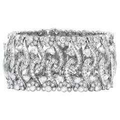 Diana M. 18kt white gold wide, flexible fashion heart bracelet featuring 32.50ct