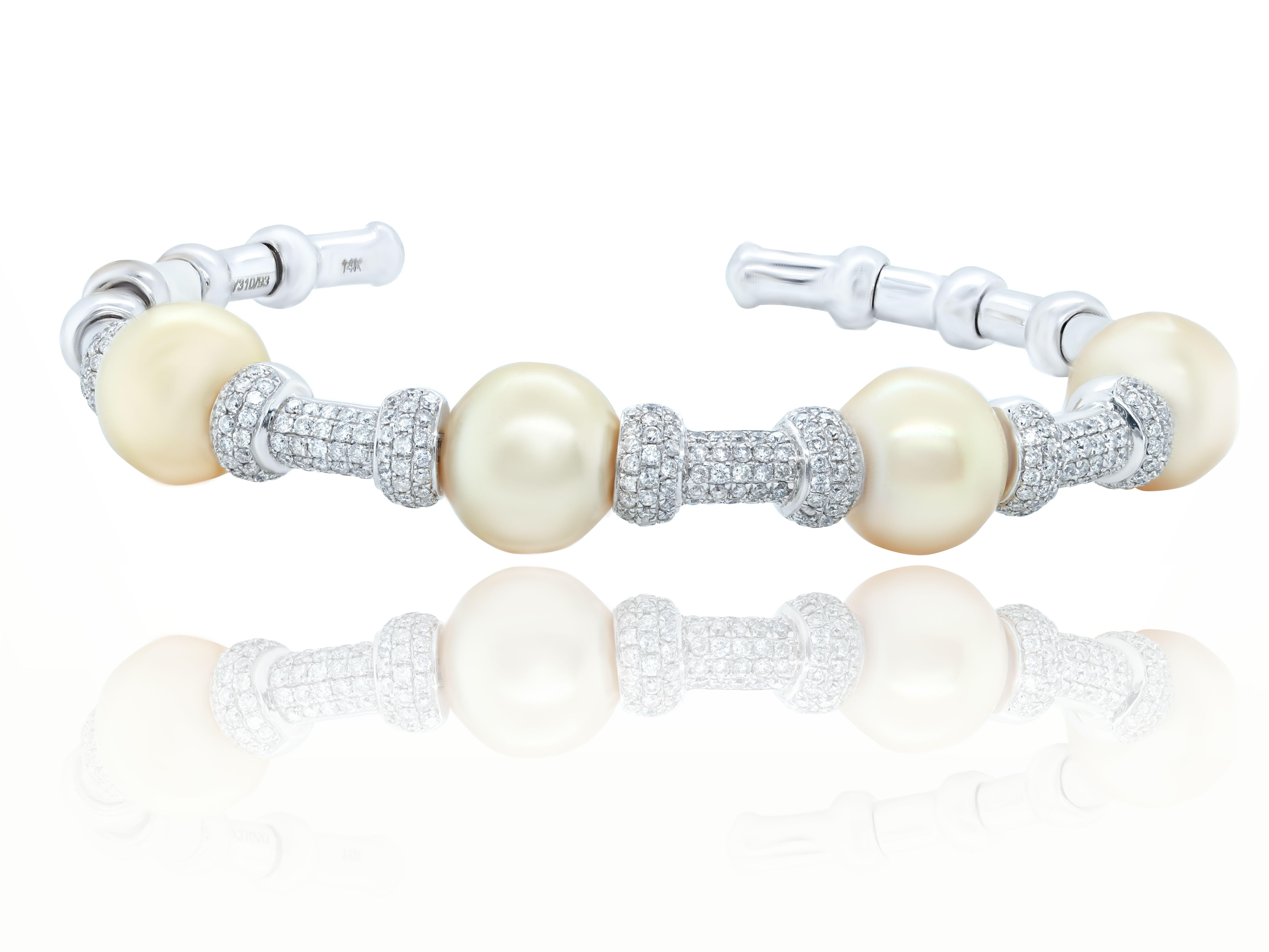18 kt white gold diamond and pearl cuff featuring 11.5 mm yellow pearls separated by rondels adorned with 1.90 cts tw of diamonds