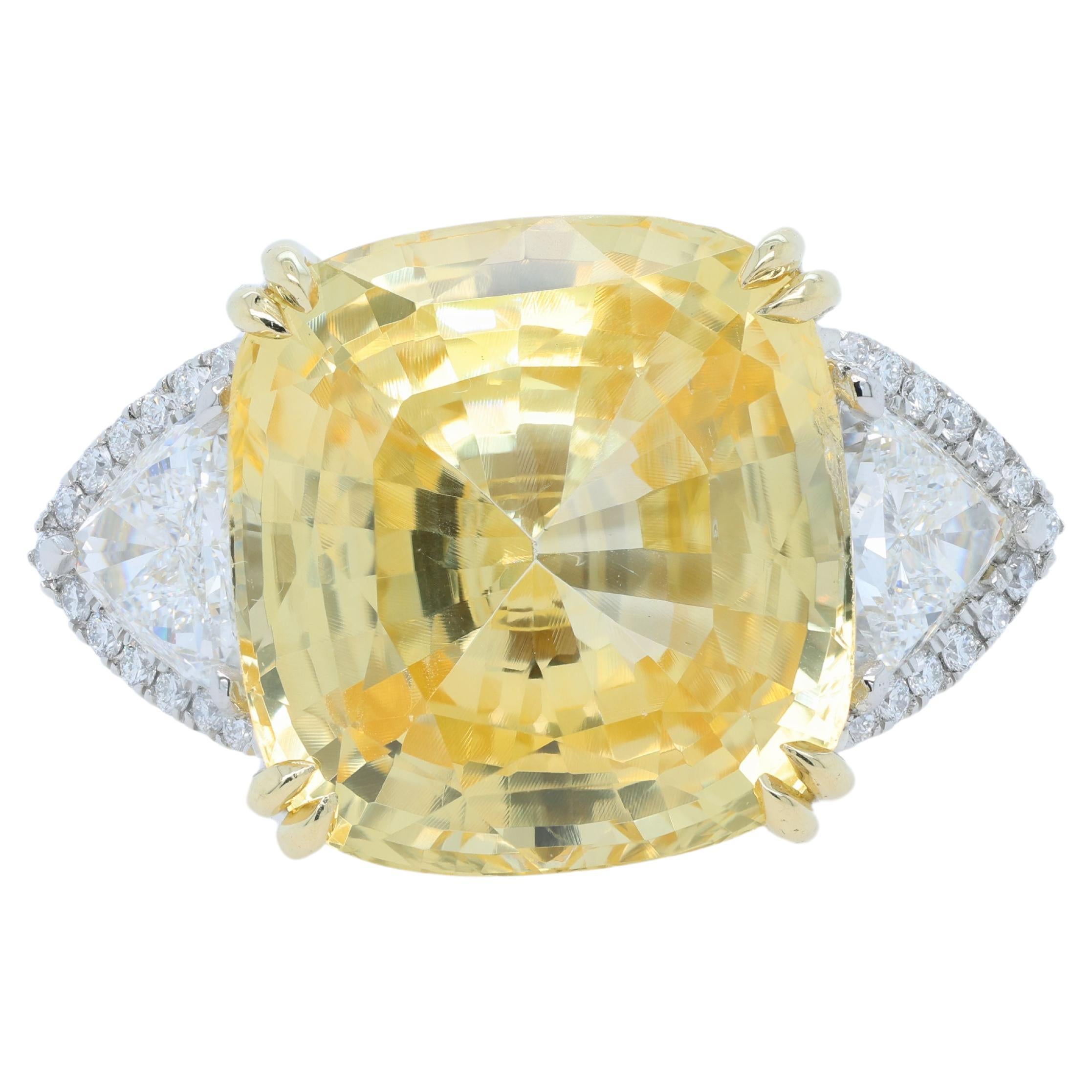 18kt platinum and yellow gold yellow sapphire ring.  This ring has a center yellow sapphire 23.33cts no heat from Sri Lanka with 2 trillion  on side with halo around 2.60cts 
