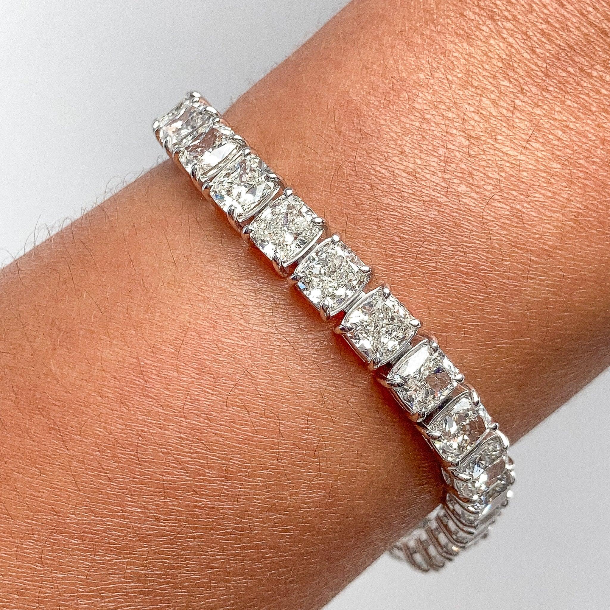 Platinum tennis bracelet adorned with 30 diamonds, totaling 30.17 carats. Each diamond weights over one carat.   The diamonds showcase are H to I in color reflecting near colorless hues, and exhibit VVS2-SI1 clarity, every diamonds is accommodated