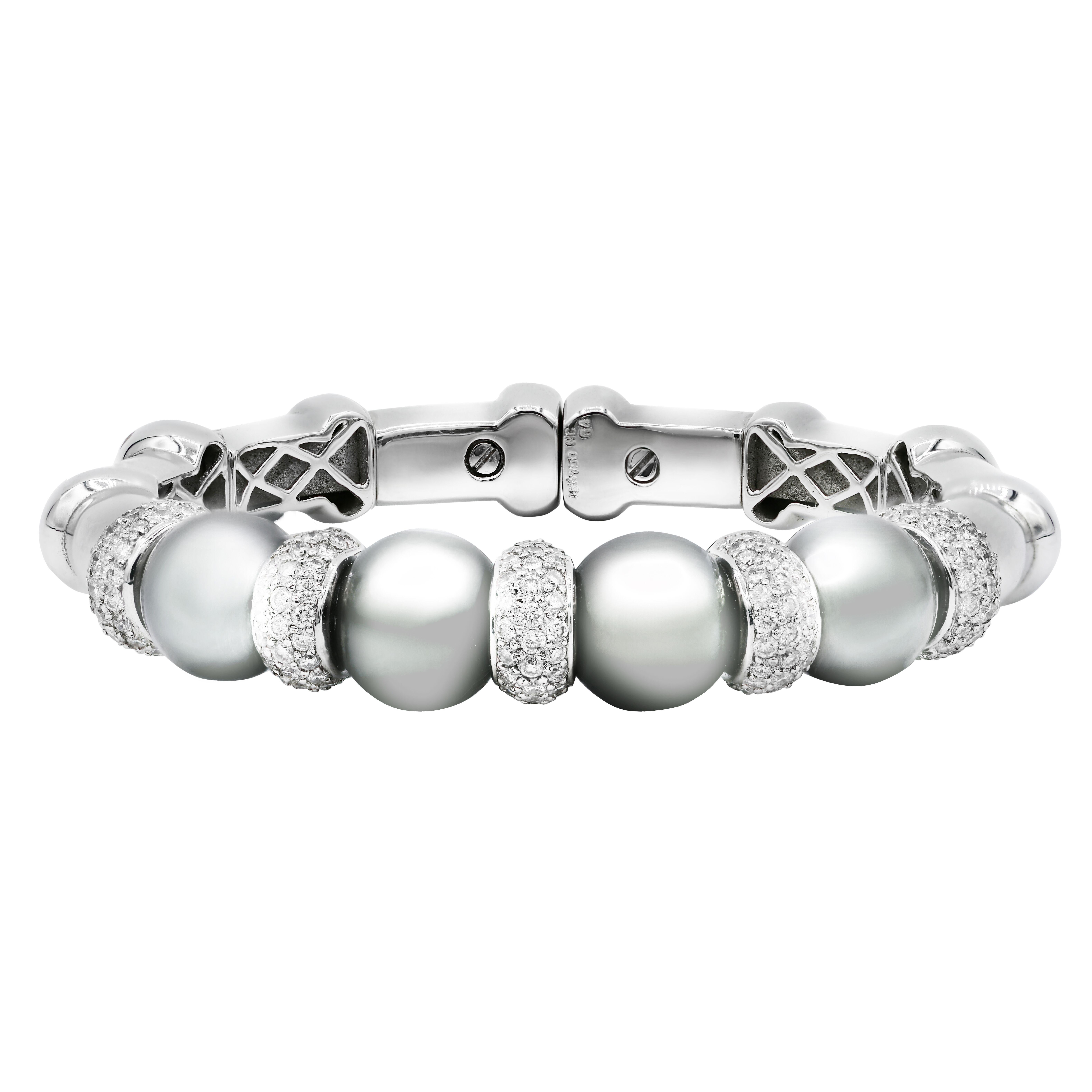 18 kt white gold diamond and pearl cuff featuring four 11.9 mm white pearls separated by rondels adorned with 3.20 cts tw of round diamonds 