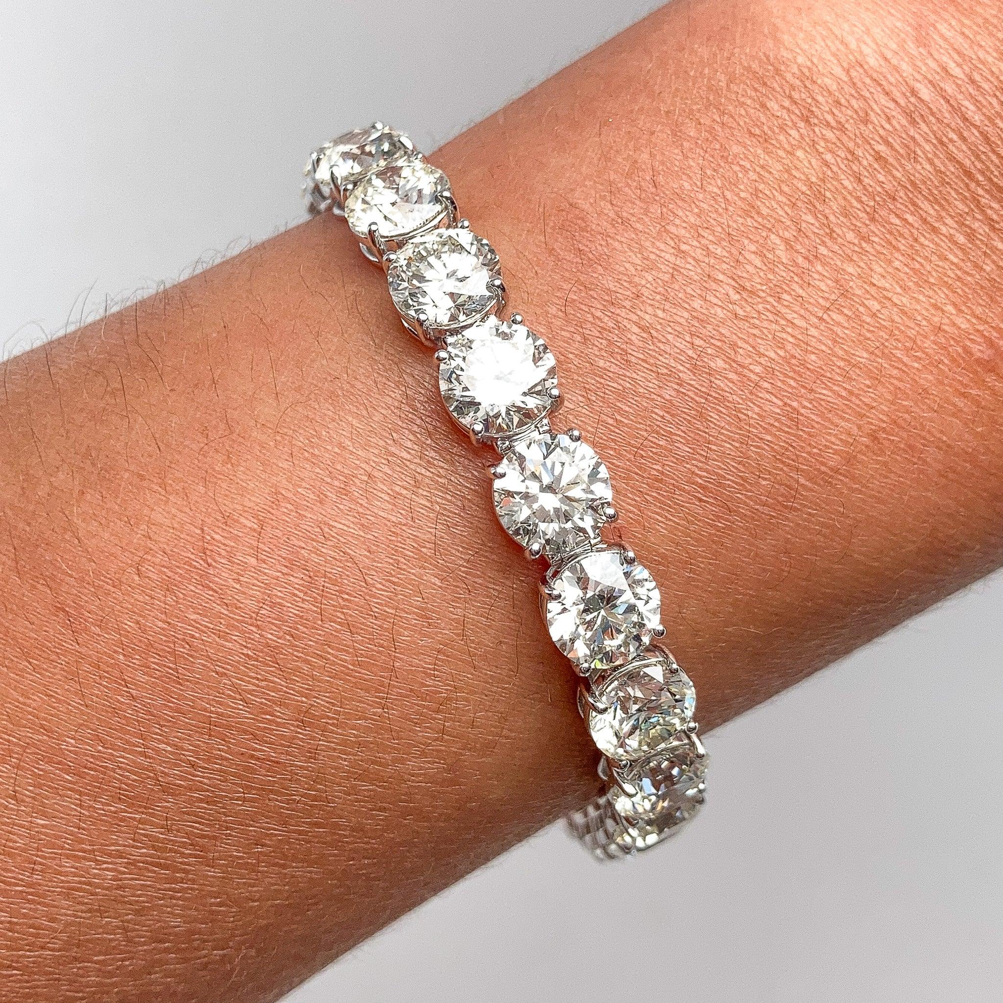 Behold this exquisite 18KT tennis bracelet, adorned with a mesmerizing total of 34.60 carats of dazzling diamonds, each certified by GIA and boasting a size exceeding 1.50 carats. This stunning piece exhibits near-colorless  brilliance and