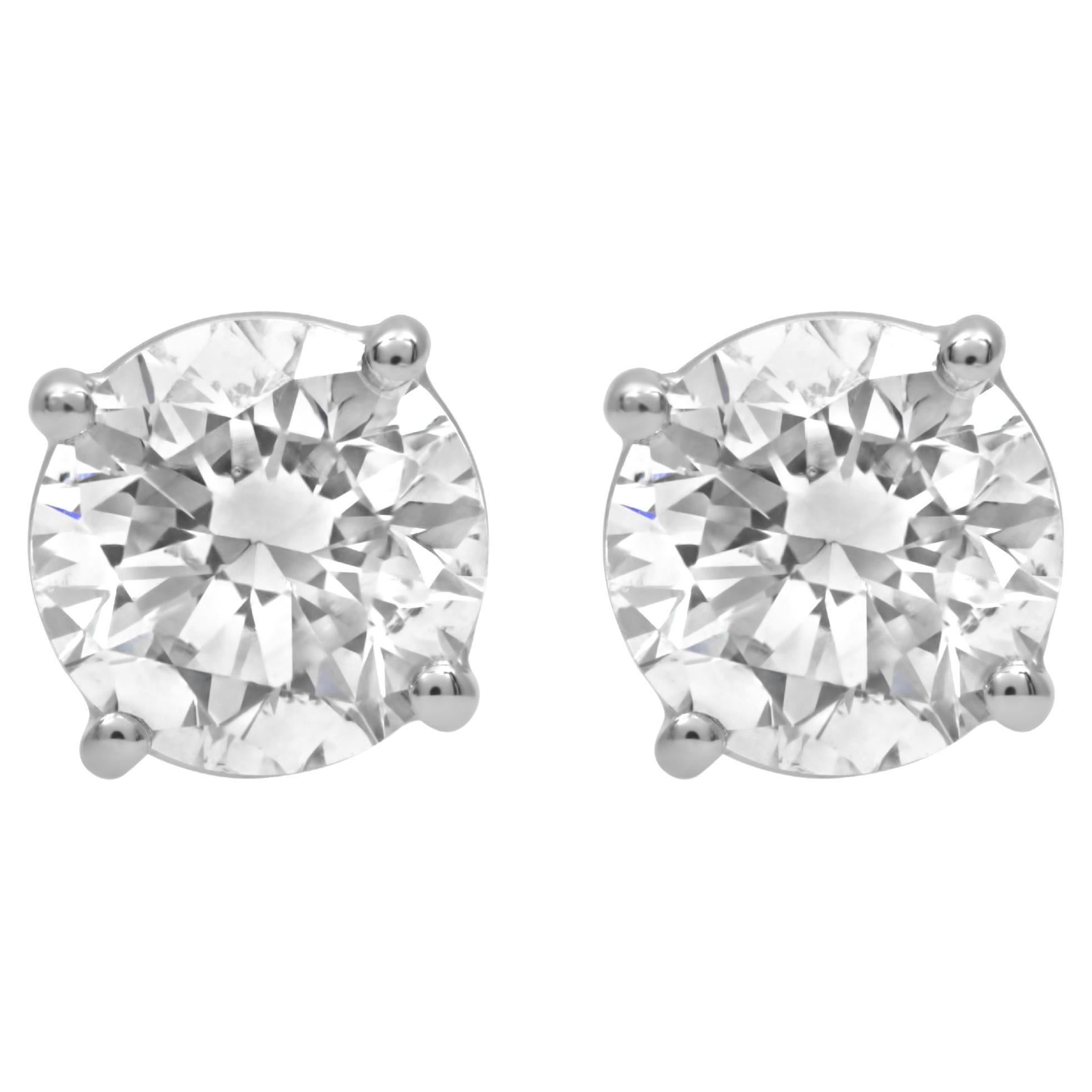 14kt white gold 4 prong stud earrings featuring 4.55 cts of round diamonds (HI SI) screw backs