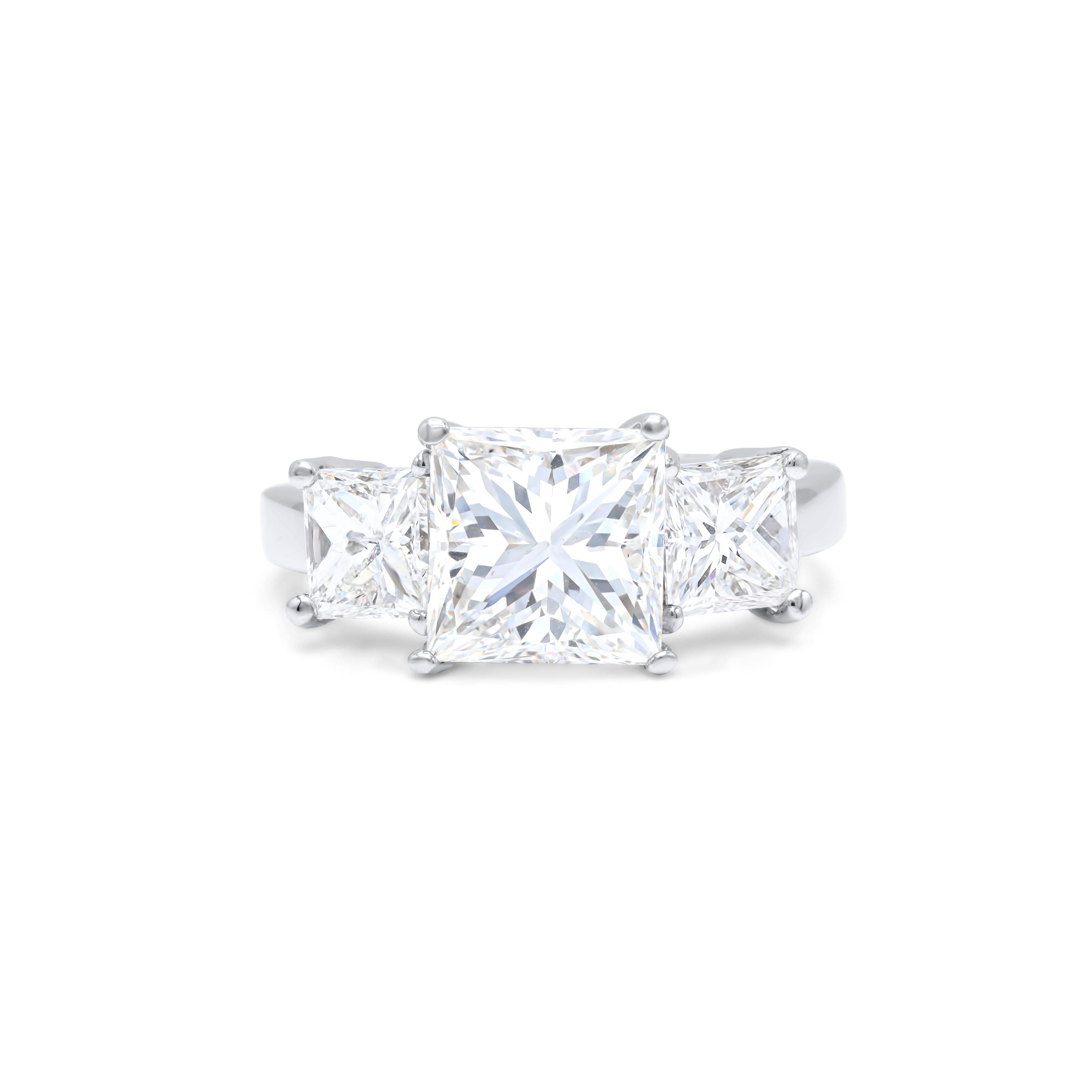 18 kt white gold engagement ring featuring a center 4.01 ct clarity enhanced diamond with 2.03 cts tw of 2 princess cut diamonds on the sides 
