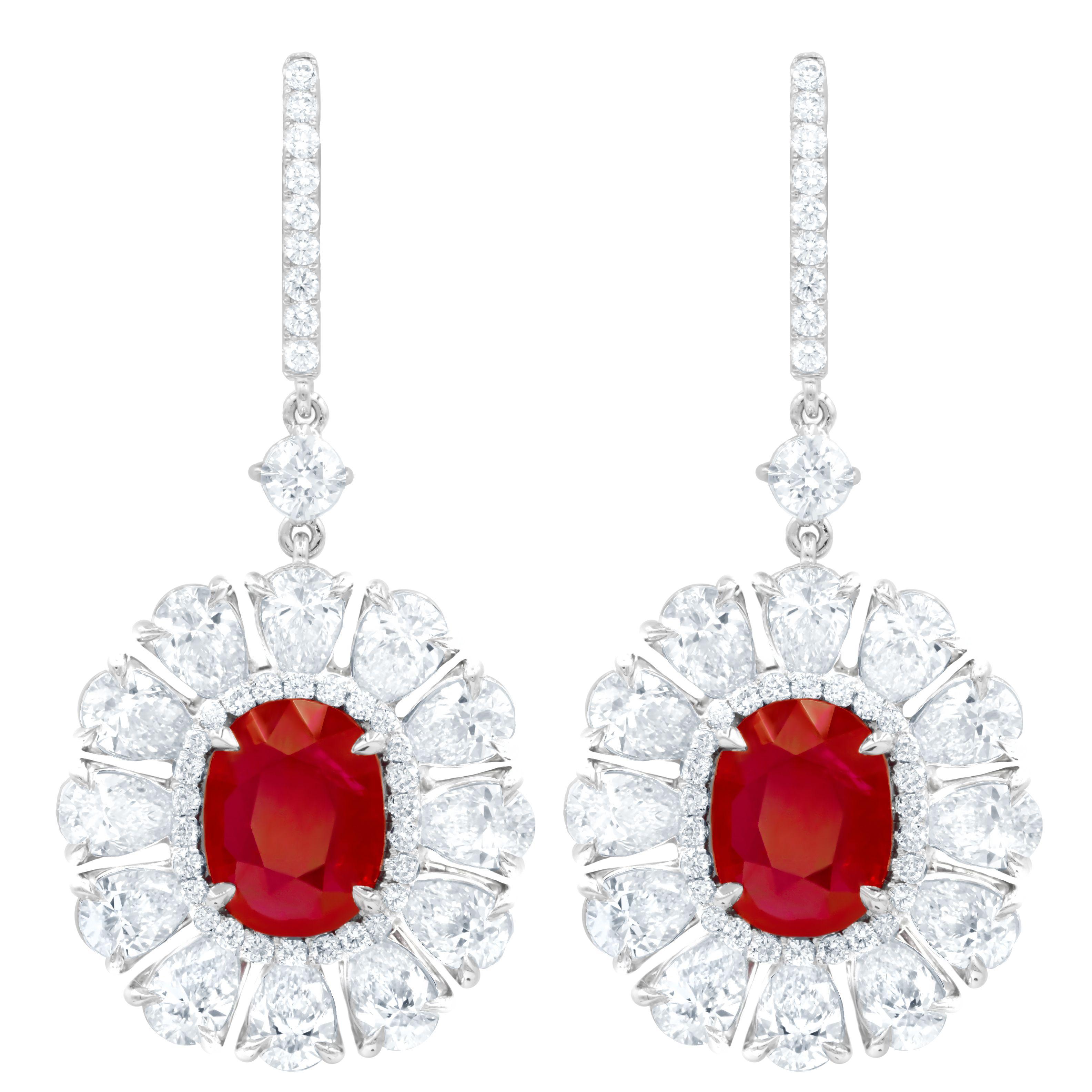 18kt white gold oval shape ruby GIA Certified earrings features: 6.69ct ruby, set in a halo with pear shape diamonds all around shaped like a flower with a total of 8.30cts of white diamonds.