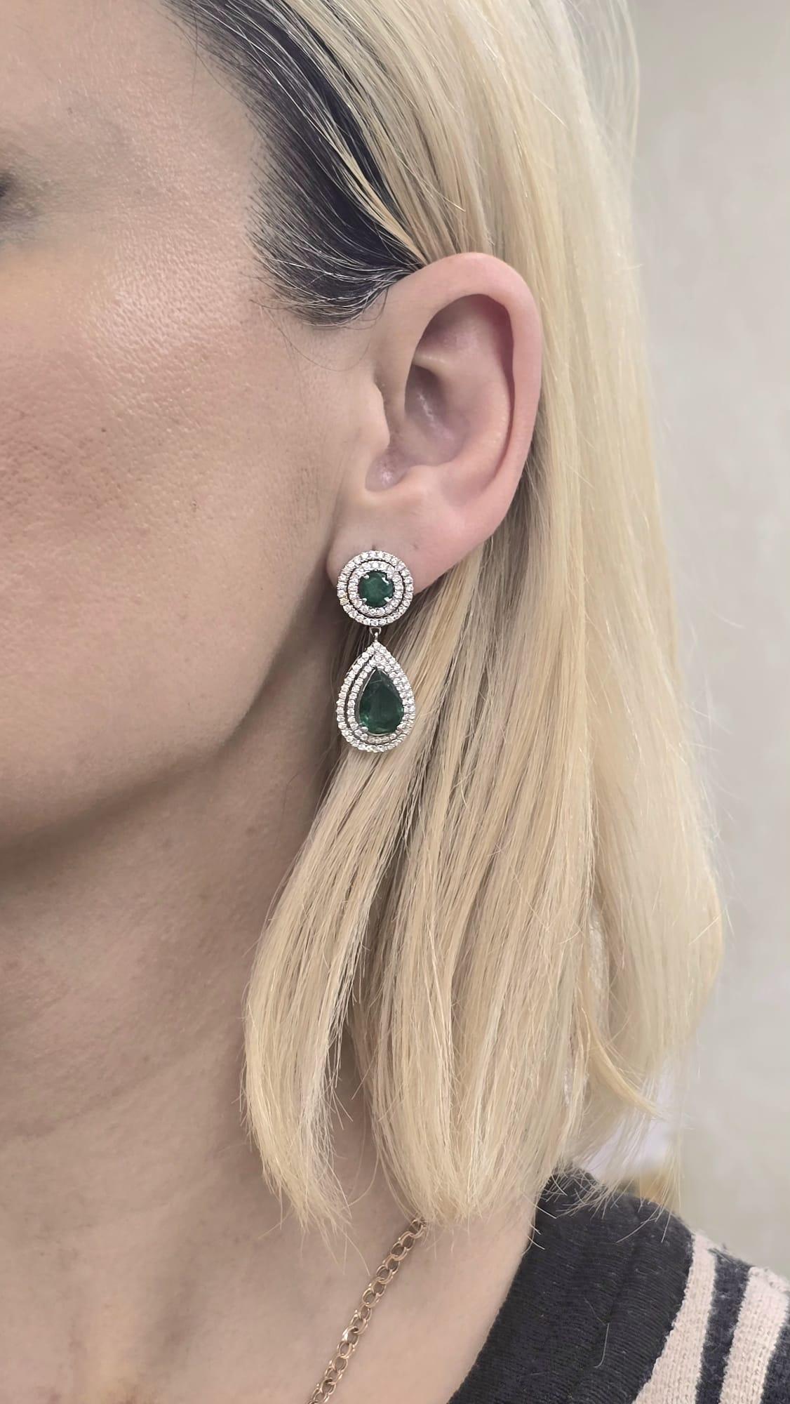 18 kt white gold fashion earrings featuring center 6.04 cts tw pear shaped emeralds surrounded by 2 pear shaped rings adorned with 1.60 cts tw of diamonds C. Dunaigre
