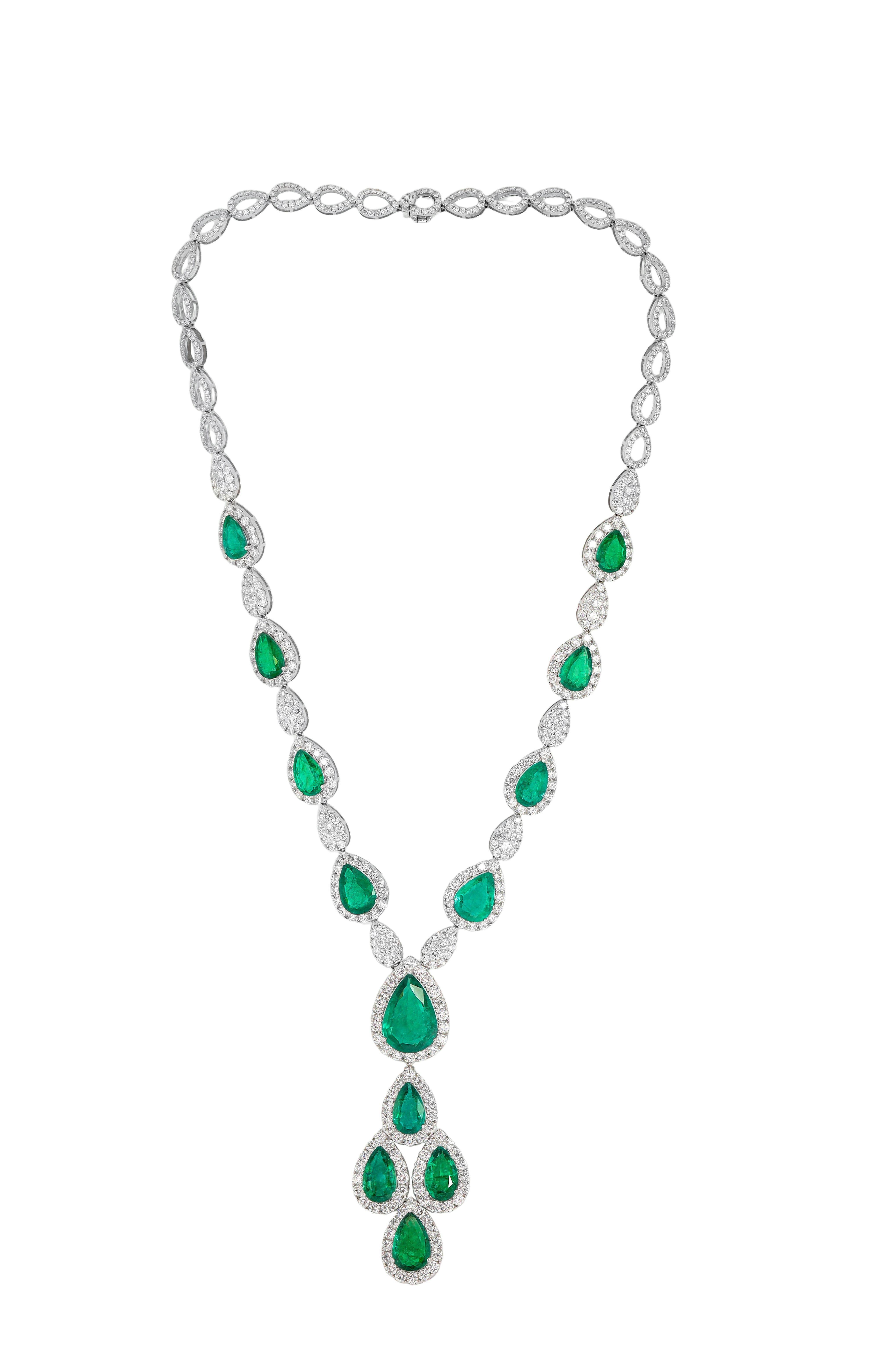 18kt white gold diamond necklace features 32.19 cts pear shape emeralds and 16.80 cts white diamonds. 
C. Dunaigre Certified