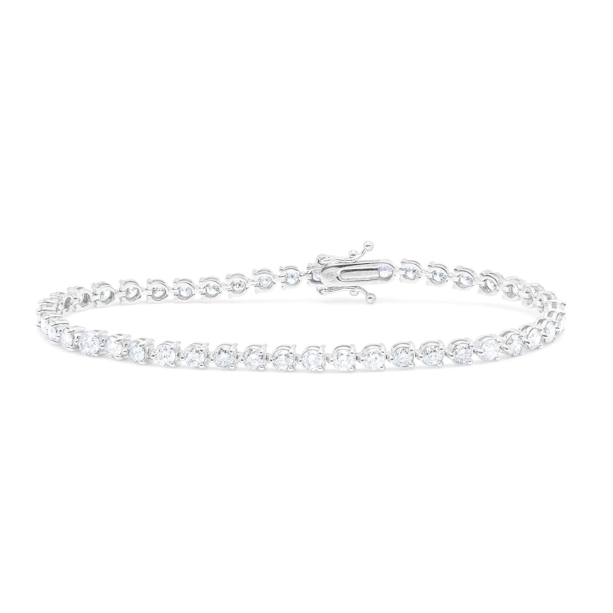 Custom 14kt white gold diamond tennis bracelet 4.50 cts of round diamonds in a 3 prong buttercup setting 44 stones  0.06 each GH color SI clarity.  Excellent Cut.
