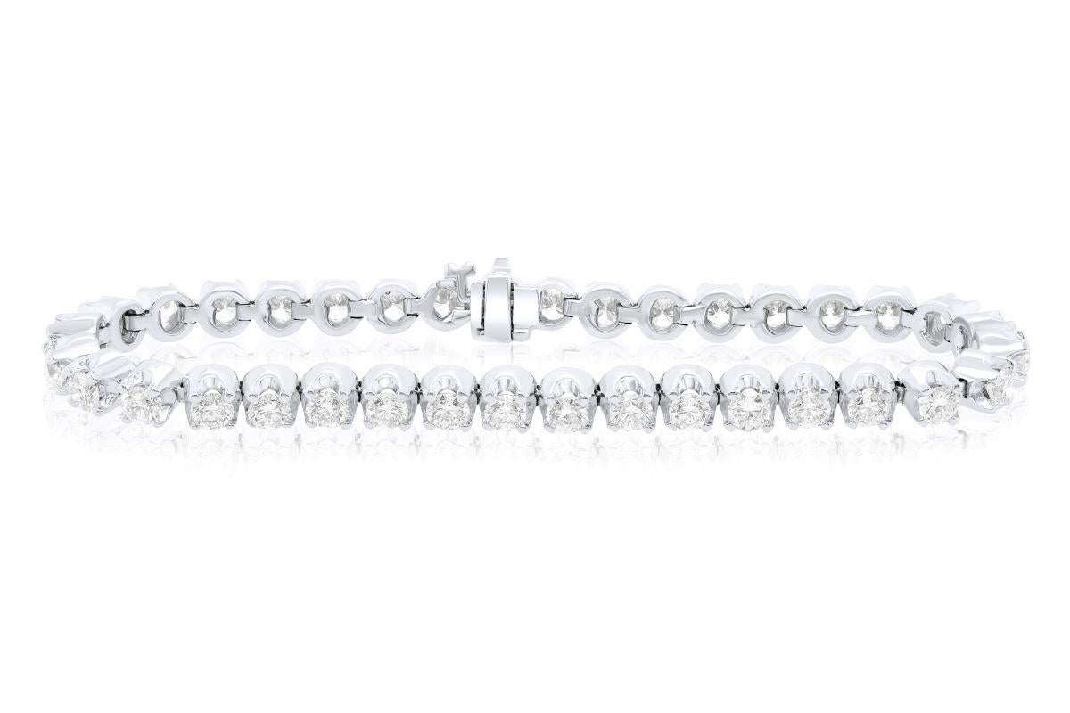 14kt white gold tennis bracelet featuring 6.60 cts tw of round diamonds in a buttercup setting GH SI