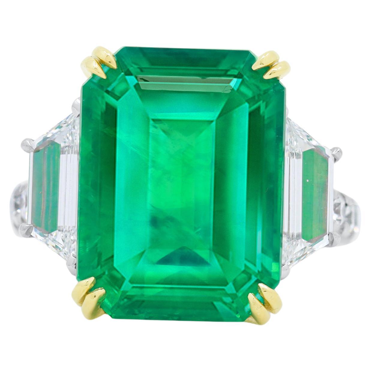 Platinum and 18 kt yellow gold emerald and diamond ring featuring a 12.53ct emerald F1/F2- with 1.60 cts tw of diamonds with step cut trapezoid in a halo setting 
Diana M. is a leading supplier of top-quality fine jewelry for over 35 years.
Diana M