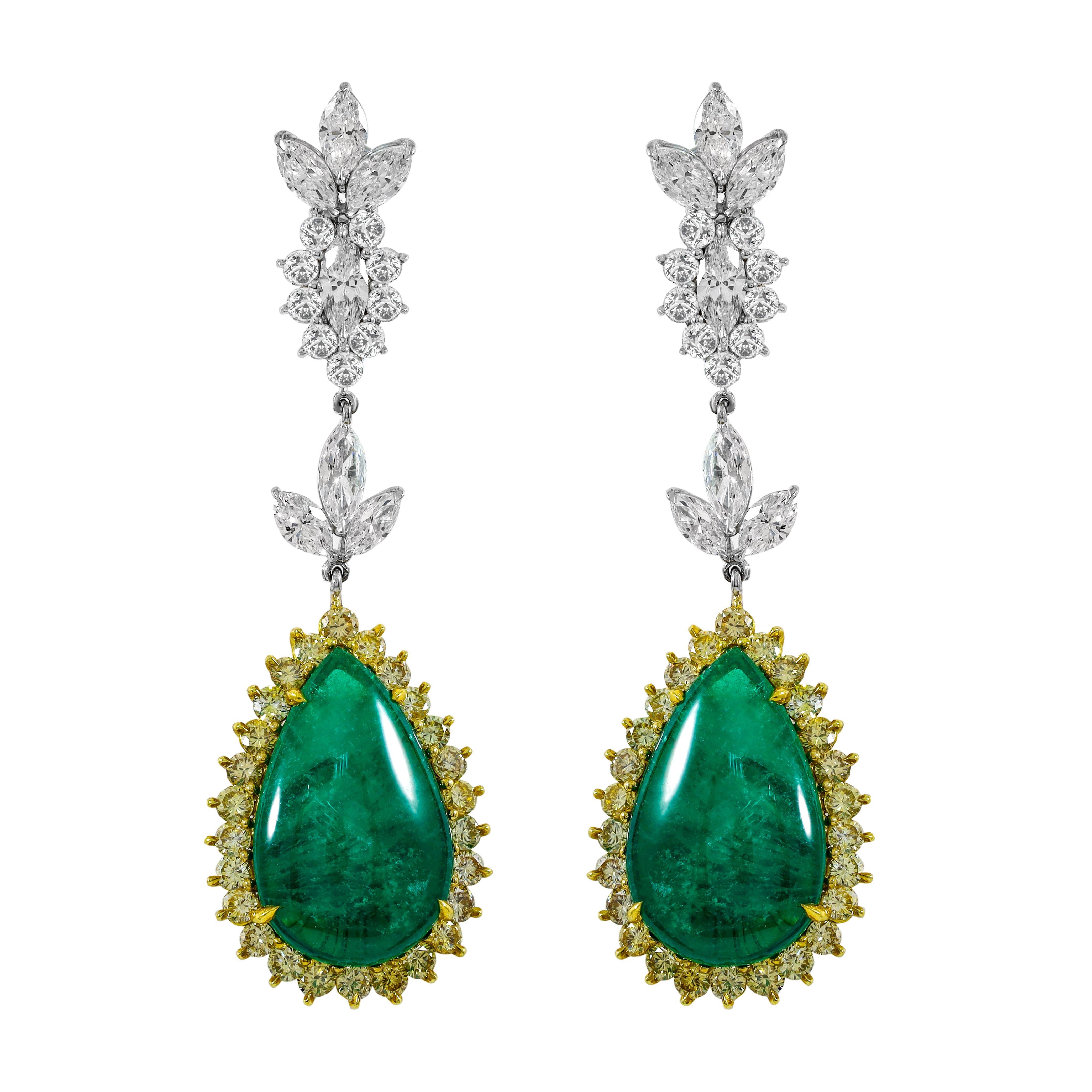 18kt white and yellow gold, features 14.05 carats of  GIA#2151989321 certified two pear cabochons green emeralds with 7.60 carats of diamonds marquise & round.