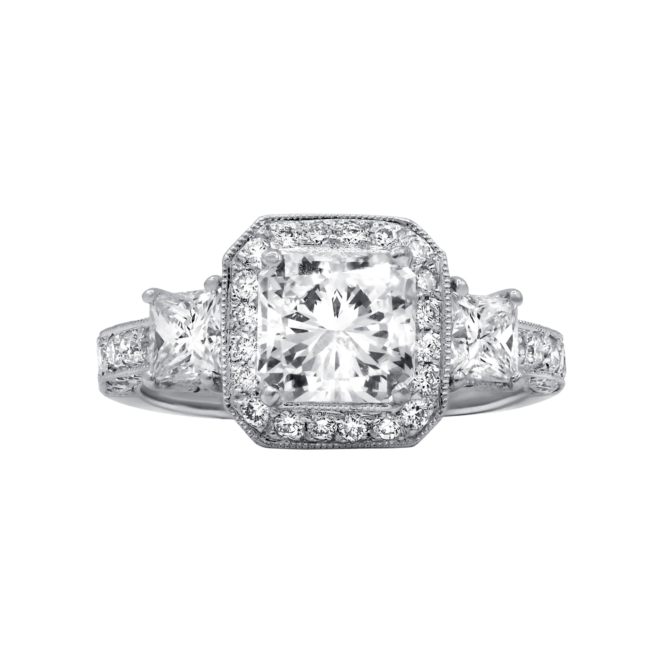 18 kt white gold engagement ring featuring a 1.52 ct GIA certified (G-VVS1) radiant cut diamond(RADC329) surrounded by 0.90 cts tw of diamonds in a halo filigree setting