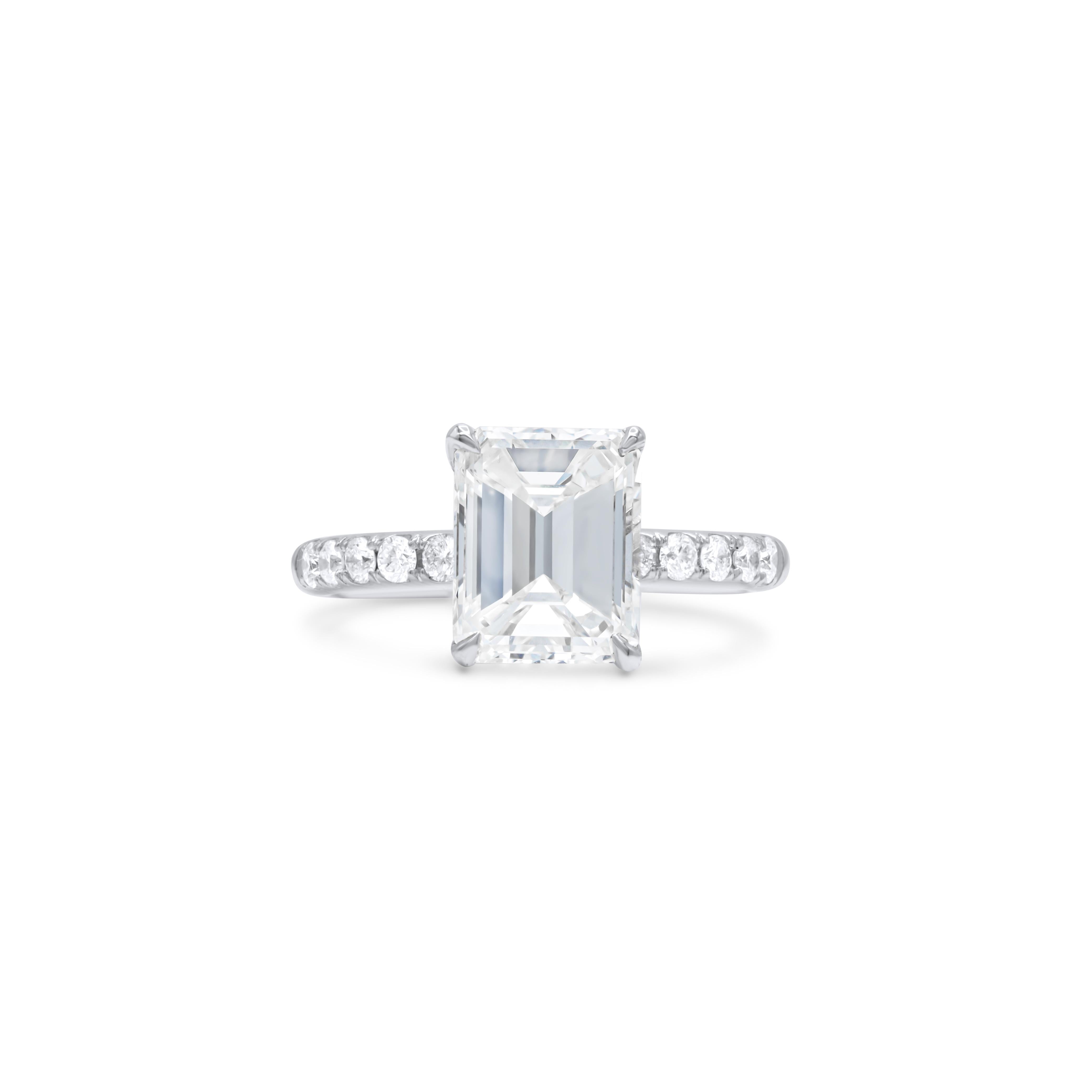 18 kt white gold engagement ring featuring a center 3.01 ct emerald cut diamond(GIA#2215470043) (J-VS2) with 0.56 cts tw of brilliant cut round diamonds on the band