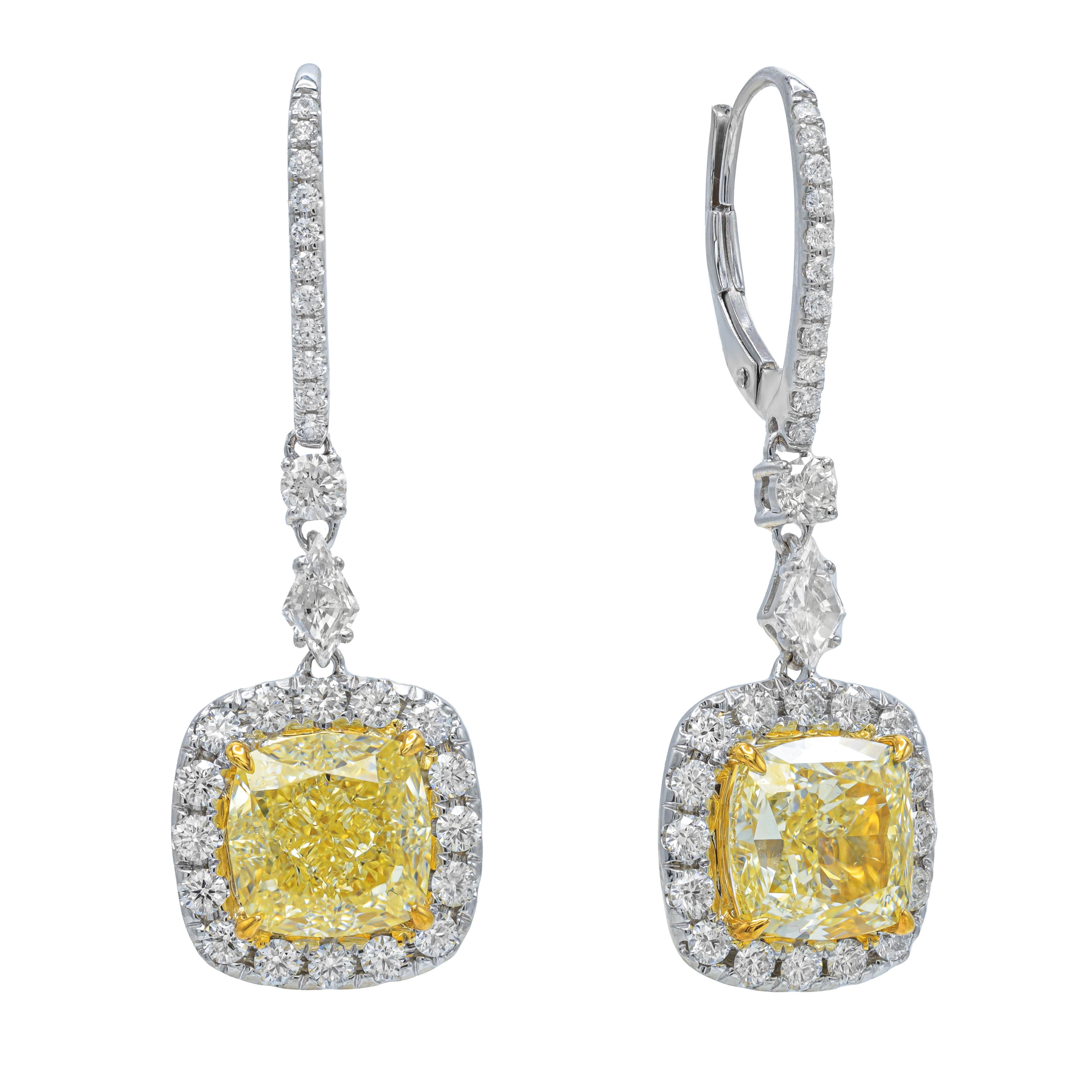18KT TWO TONE GOLD FANCY LIGHT YELLOW DIAMOND EARRING SET IN A HALO SETTING, FEATURES GIA CERTIFIED YELLOW DIAMONDS, 3.21CT VVS2 AND 3.26ct VVS2OF FANCY LIGHT YELLOW CUSHION CUT DIAMONDS AND 1.40 CARATS OF WHITE DIAMONDS AROUND F-G/VS