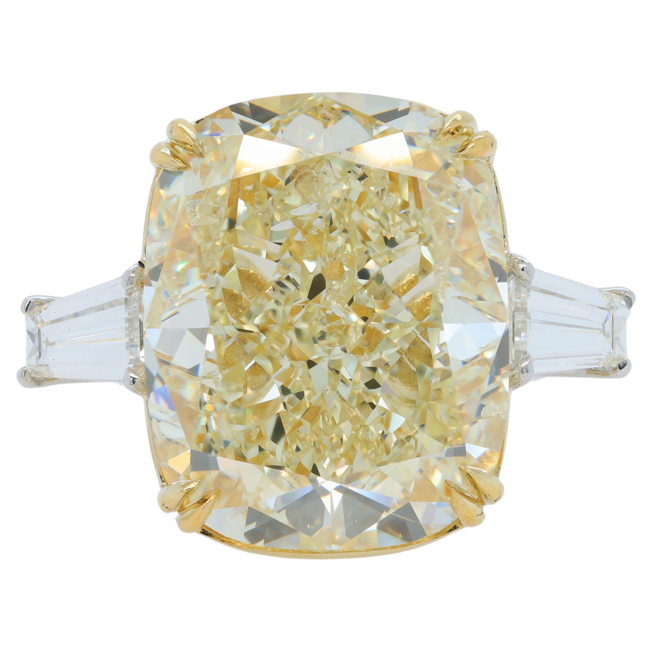 Platinum and 18 kt yellow gold engagement ring featuring a center (FLY SI2) 25.88 ct cushion  cut yellow diamond(GIA# 6234074857-RADC1138) with 1.70 cts tw of trapezoid  diamonds on the sides GIA certified .80ct J VS2 #2231049204 and .89ct I