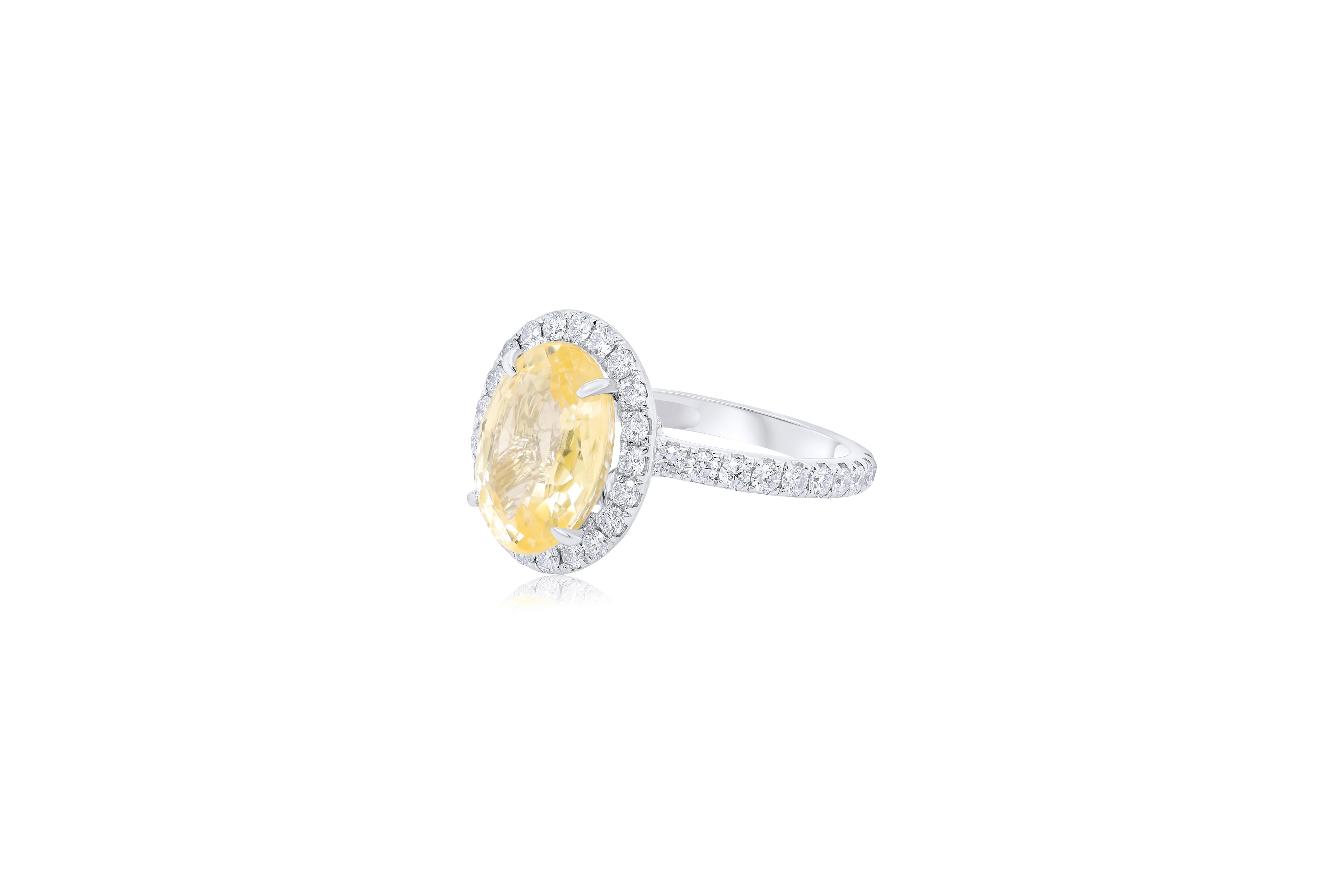 Custom classic sapphire diamond ring with yellow oval shape sapphire 7.57ct set in a halo with round diamonds 1.30ct all the way around center and three quarters of the way around the band in 18kt white gold setting.
Natural No heat 7.57 Sapphire 