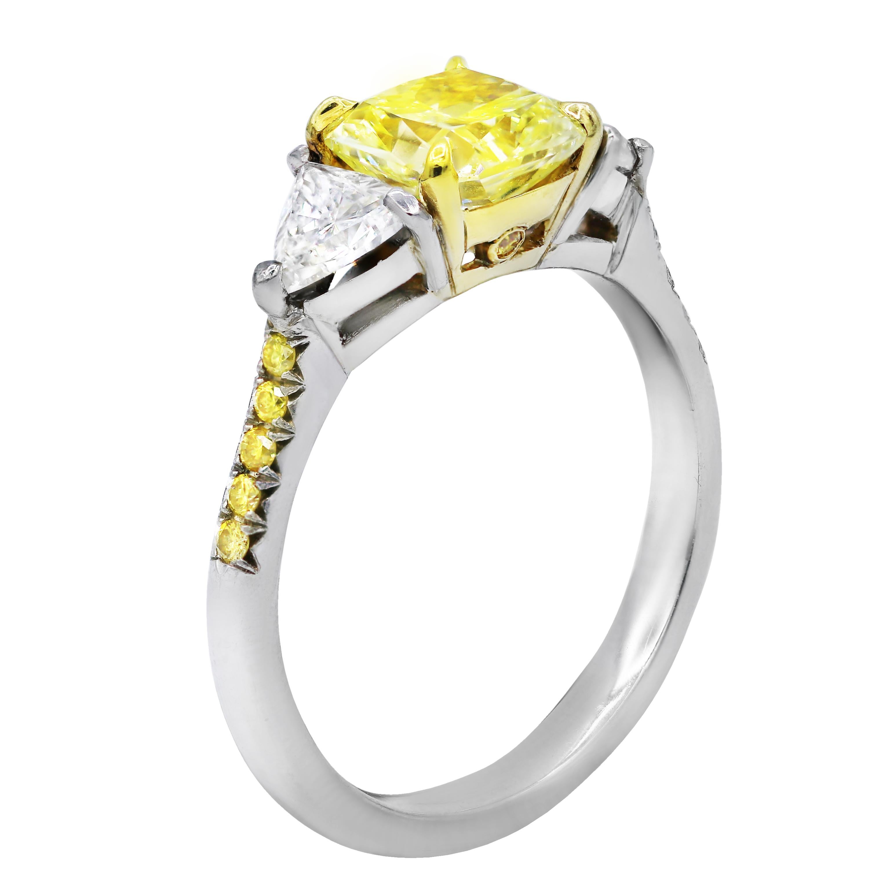 Platinum and 18 kt yellow gold engagement ring featuring a center (FY VS2) 1.42 ct radiant cut yellow diamond with 0.76 cts tw of trillion diamonds on the sides and round diamonds on the band
Diana M. is a leading supplier of top-quality fine