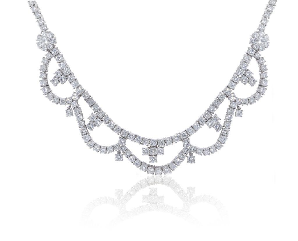 Platinum diamond necklace with flower and u-shape design featuring 26.80 cts of round diamonds 