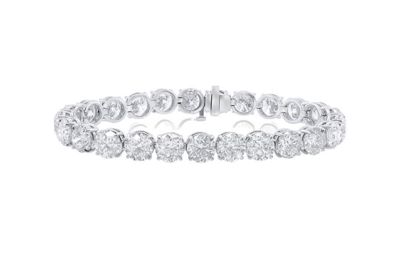 The platinum-gold custom 4-prong diamond tennis bracelet  
 28.06 cts round diamonds 1.05 carat each. Color GH. Clarity SI. Excellent Cut.