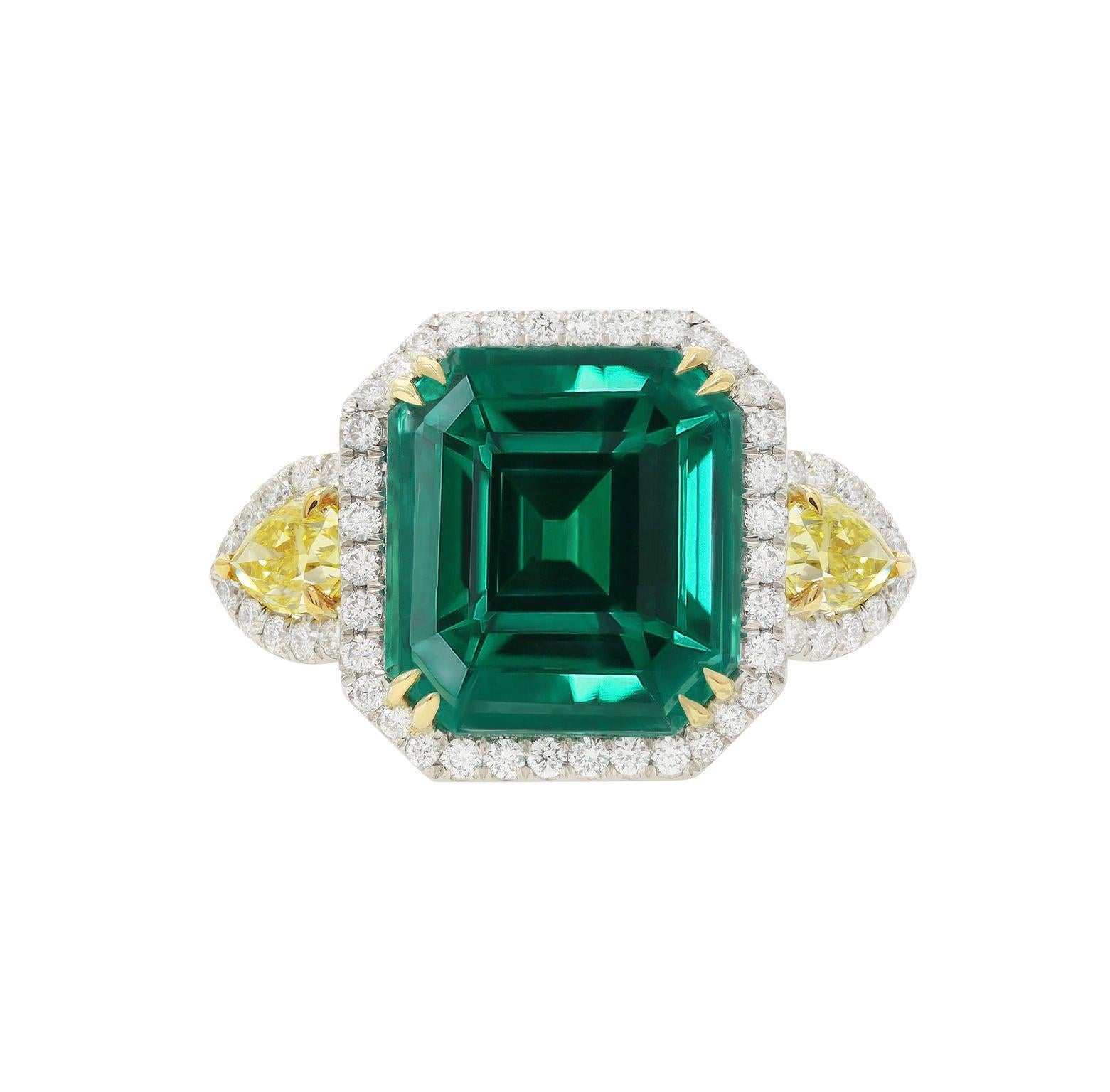 Platinum and 18 kt yellow gold emerald diamond ring featuring a 13.69 ct emerald alongside 2 pear shaped yellow diamonds totaling 0.96 cts tw on its sides surrounded by diamonds totaling 1.54 cts tw in a halo setting (C.Dunaigre certified).
Diana M.