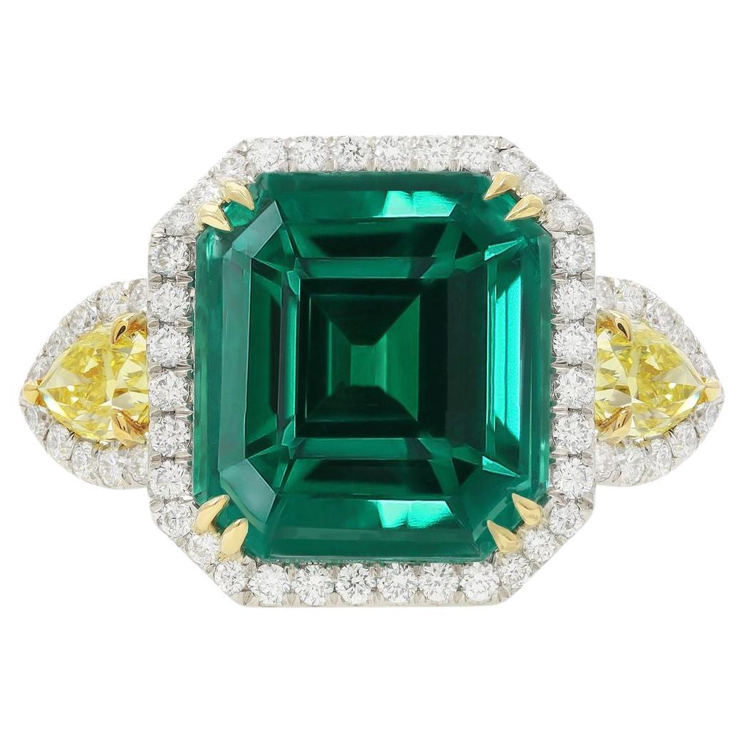 Diana M. Platinum and 18 kt yellow gold emerald diamond ring featuring a 13.69  For Sale