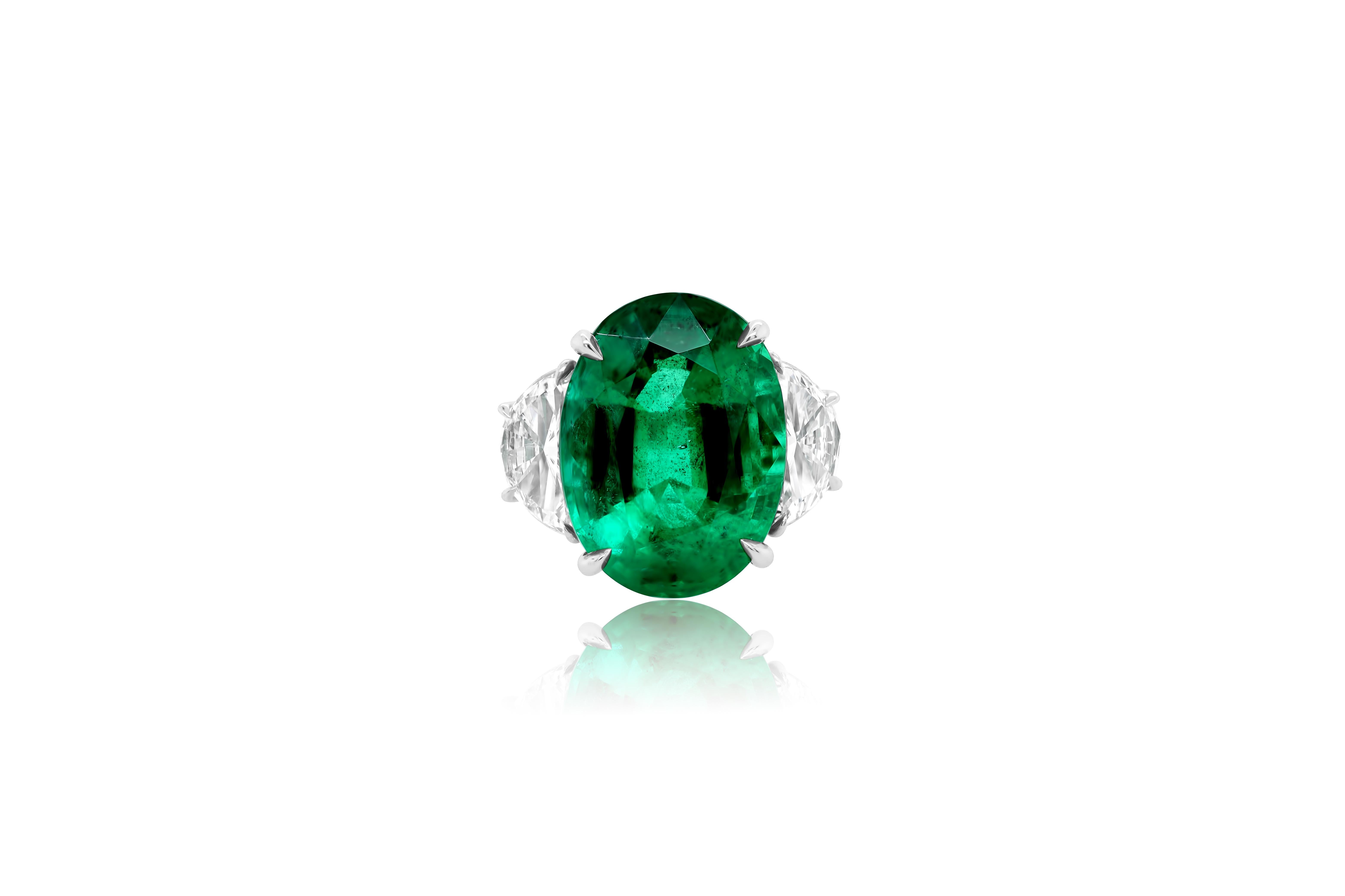 Platinum emerald and diamond ring featuring a center 13.50 ct oval cut emerald with 2  half moon shaped diamonds on the side totaling 2.50 cts of diamonds (C.Dunaigre certified).
Diana M. is a leading supplier of top-quality fine jewelry for over 35