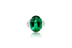 Diana M. Platinum emerald and diamond ring featuring a center 13.50 ct oval cut