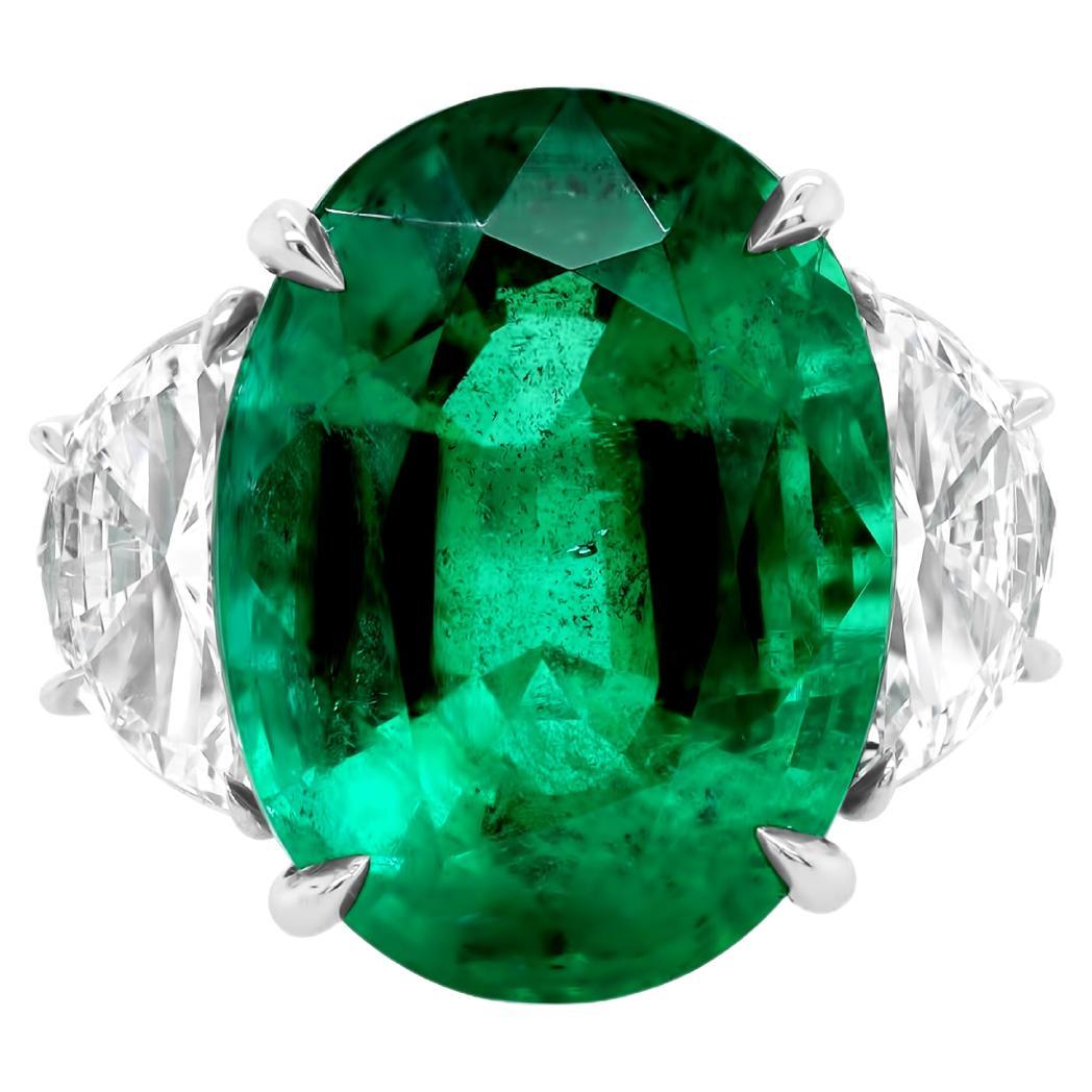 Diana M. Platinum emerald and diamond ring featuring a center 13.50 ct oval cut 