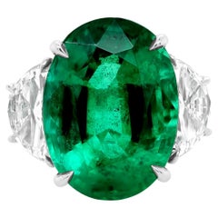 Diana M. Platinum emerald and diamond ring featuring a center 13.50 ct oval cut 