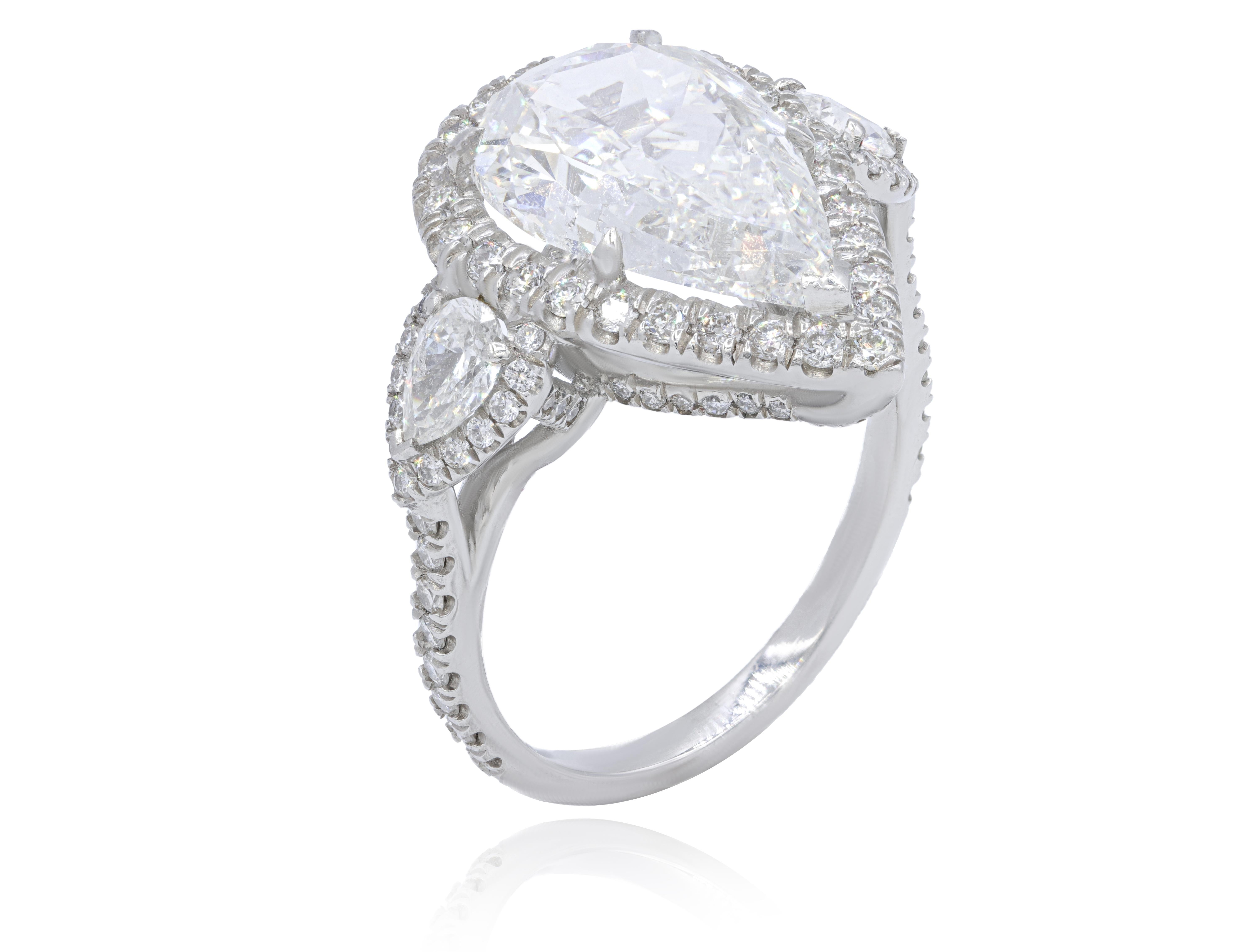 Platinum engagement ring featuring a center 5.01 ct GIA certified (G-SI2) pear shaped diamond with 2.50 cts tw of diamonds in a halo design 

Diana M is one-stop shop for all your jewelry shopping, carrying line of diamond rings, earrings,