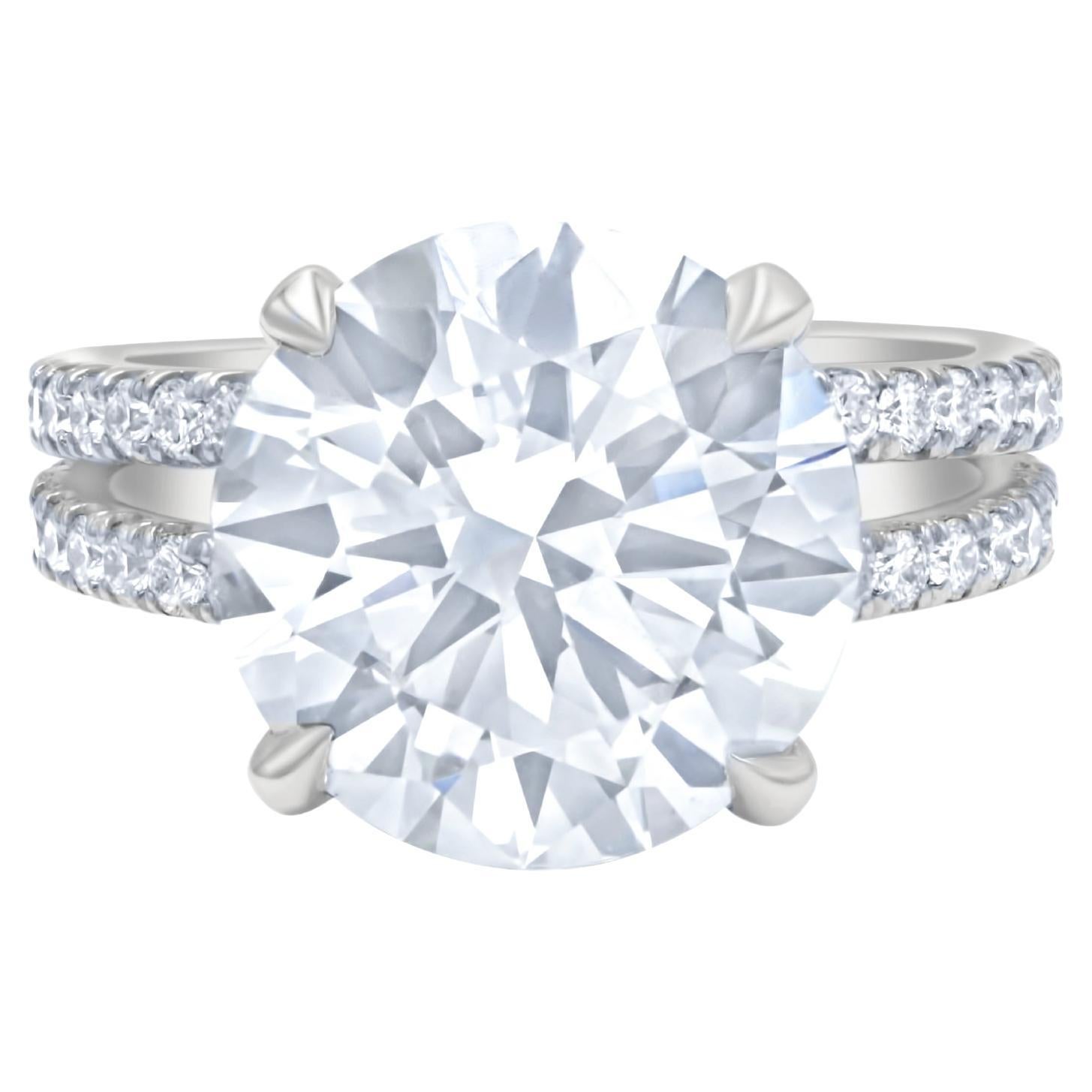 DIANA M. Platinum engagement ring featuring a center 6.30 ct round diamond For Sale