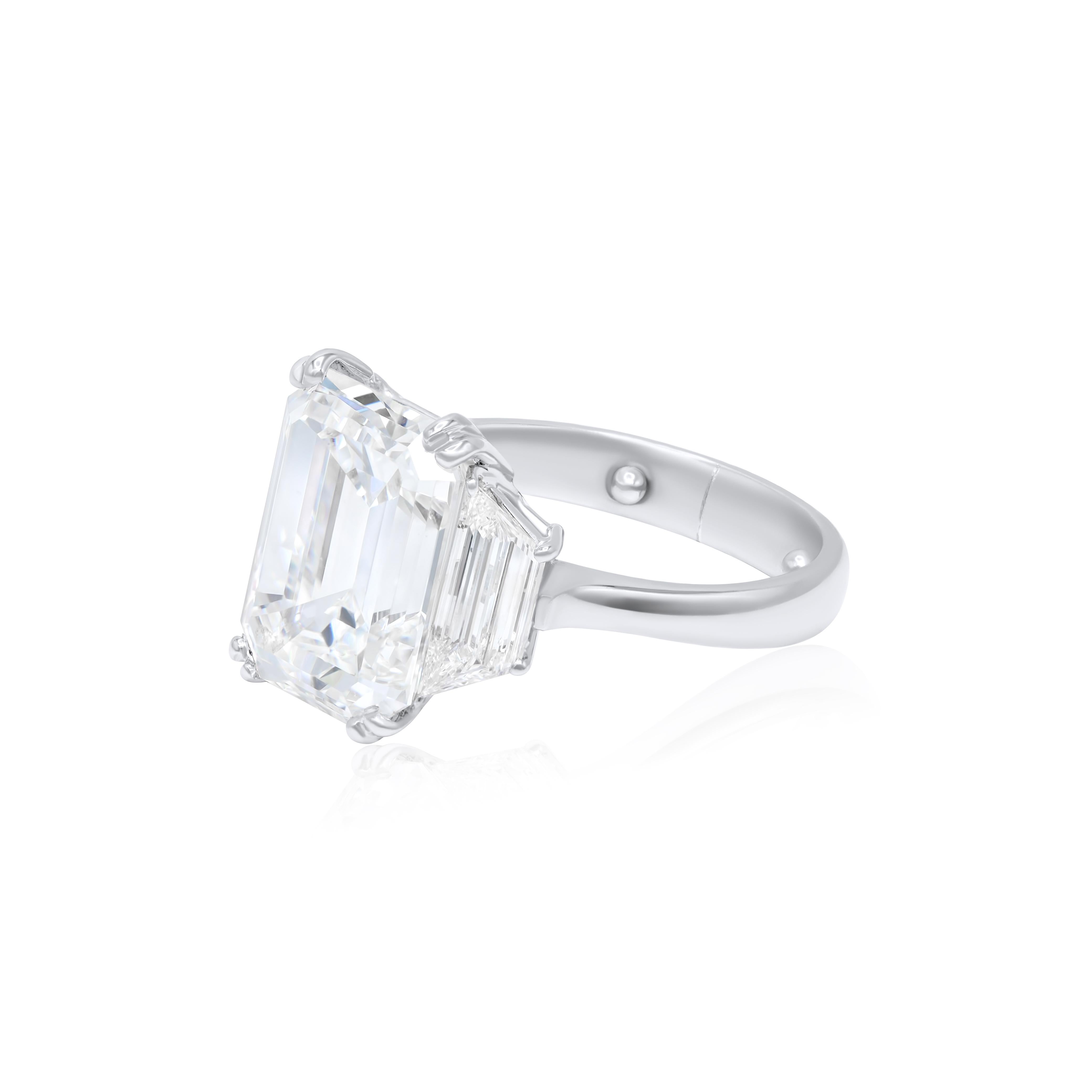 Platinum engagement ring featuring a center 8.08 ct emerald cut diamond(GIA #11042690) (E-VVS2) with 2.01 cts tw of trapezoids on the sides 
Diana M is one-stop shop for all your jewelry shopping, carrying line of diamond rings, earrings, bracelets,