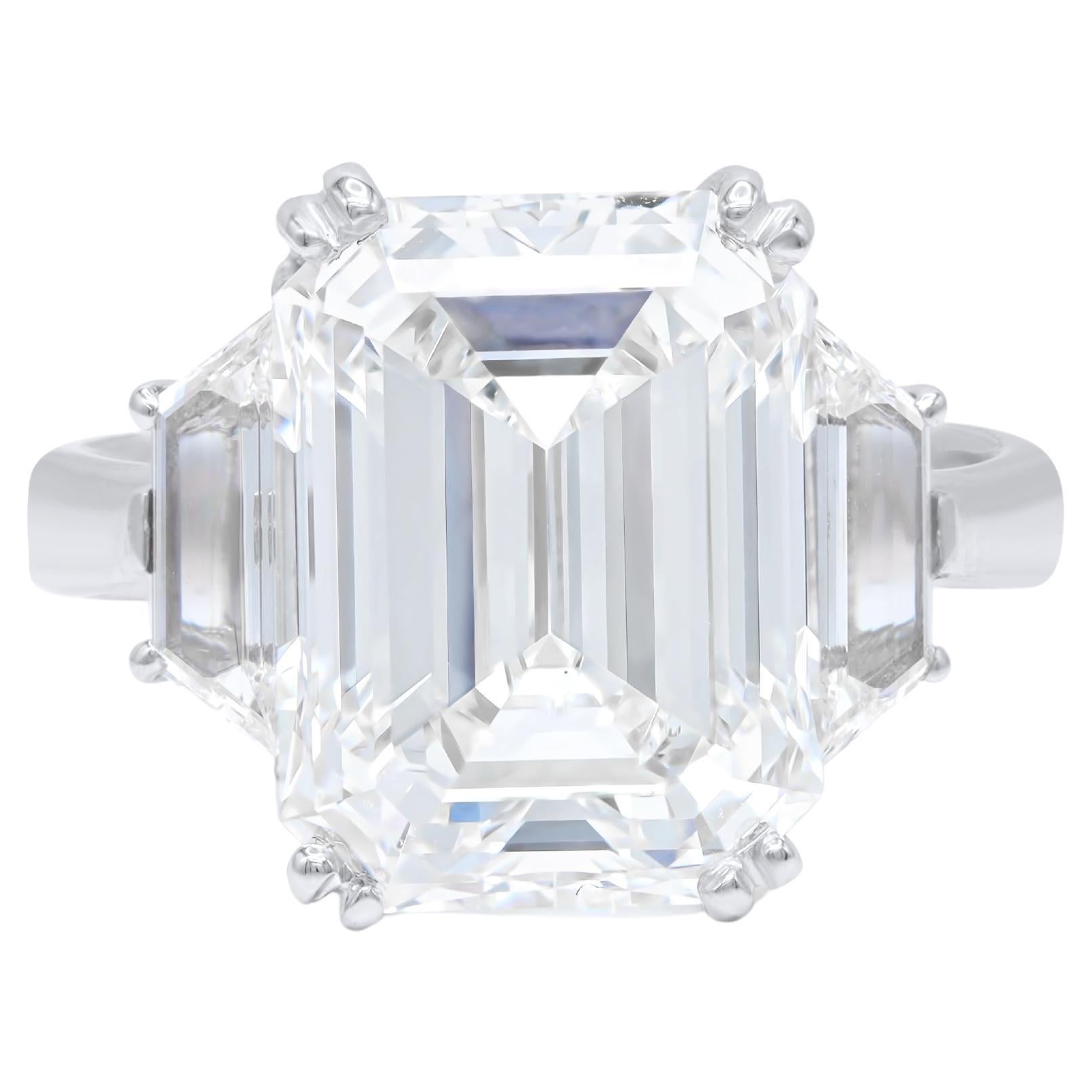 DIANA M. Platinum engagement ring featuring a center 8.08 ct emerald cut diamond For Sale