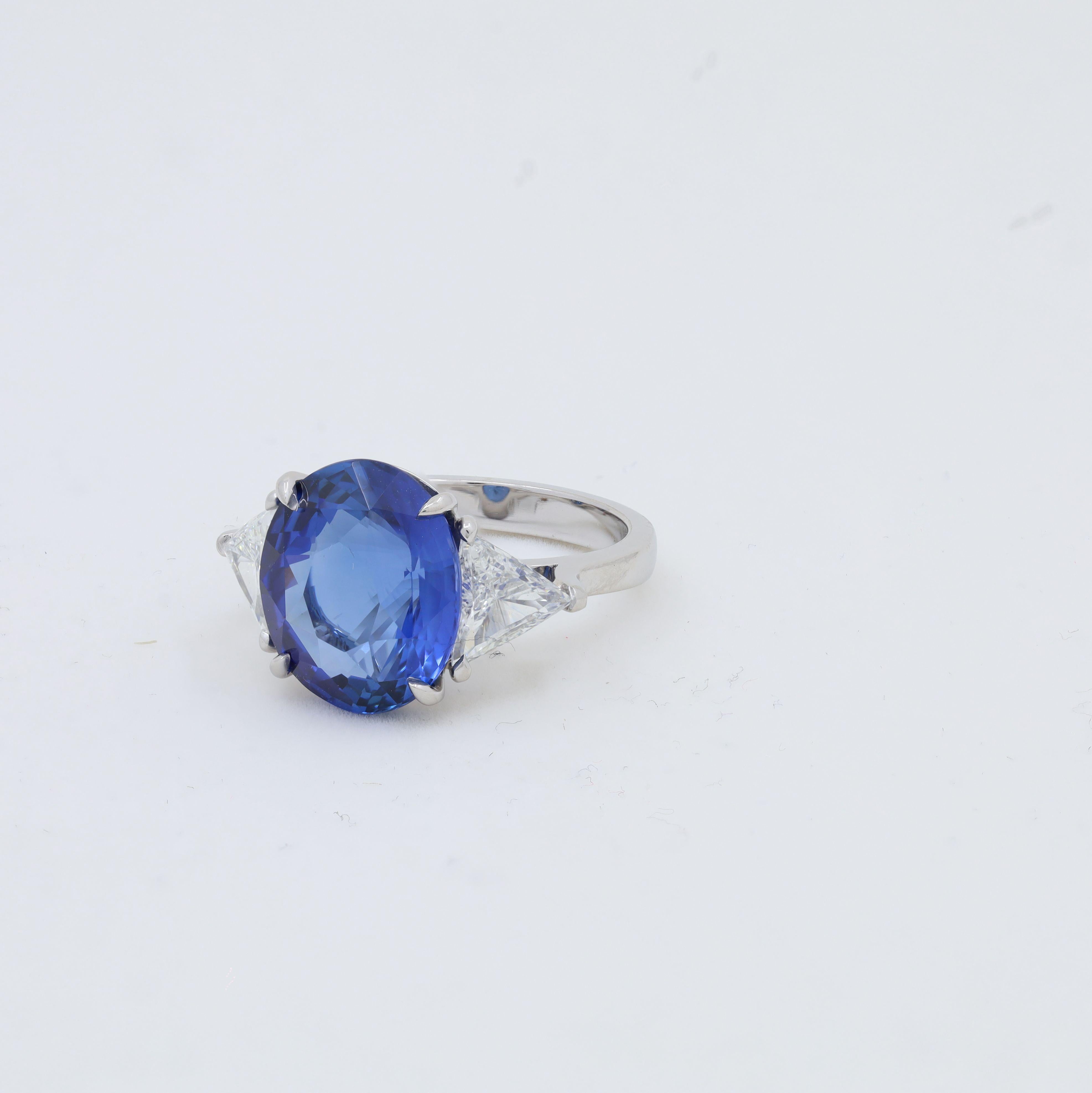 Platinum sapphire and diamond ring featuring an 8.51 ct oval certified Sri Lanka natural Ceylon blue sapphire with 2 triangle cut diamonds on its side totaling 1.27 cts of diamonds C. DUNAIGRE certified.
Diana M. is a leading supplier of top-quality