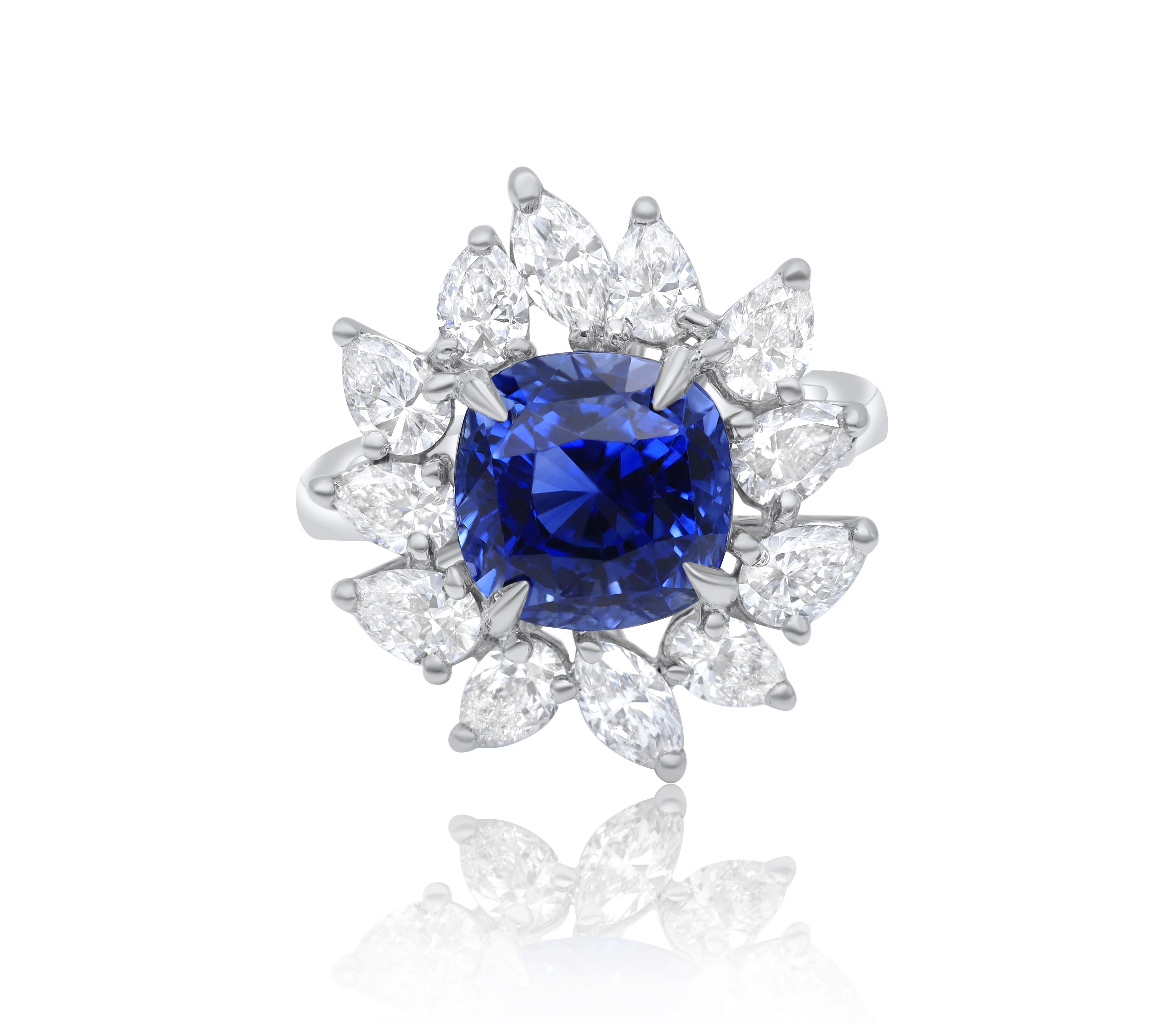 Platinum sapphire diamond Princess Diana ring featuring a 6.00 ct cushion cut sapphire (C.Dunaigre certified) surrounded by 3.02 cts tw of diamonds in a flower design.
Diana M. is a leading supplier of top-quality fine jewelry for over 35