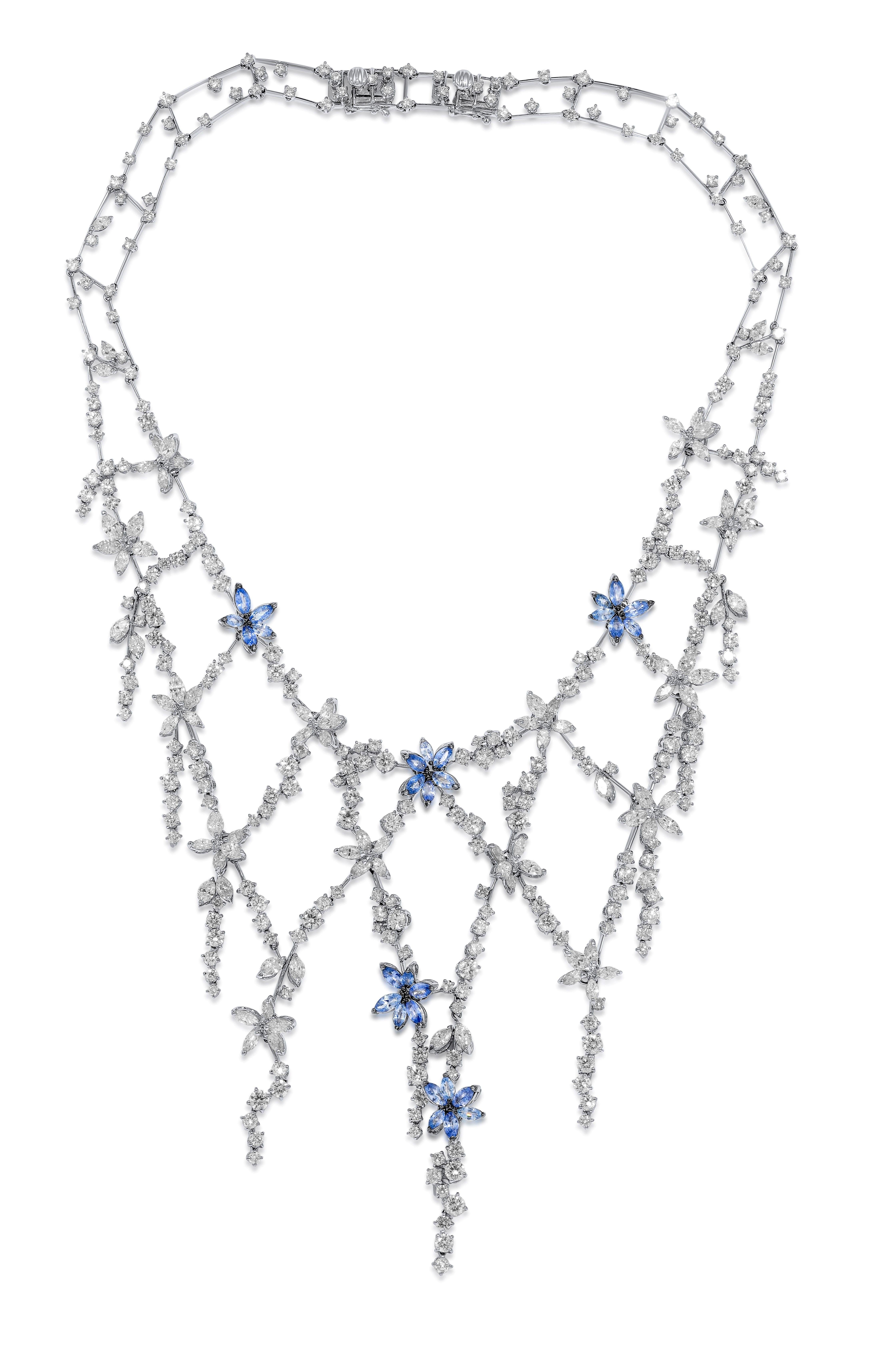 18kt white gold hanging flowers sapphires and diamonds necklace, features 6.65 carats of marquise sapphires with 35.80 carats of round and marquise diamonds.
