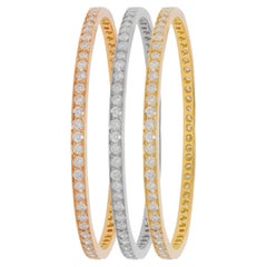 Diana M. Tri-color set of white, yellow, and rose gold bangles adorned with 23ct